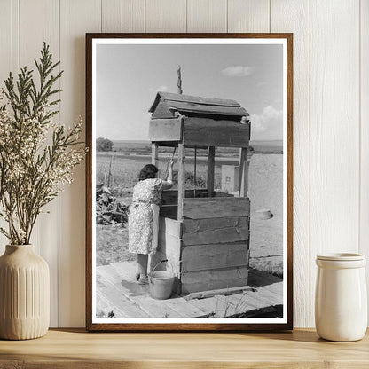 Daughter Drawing Water at Well Taos County 1939