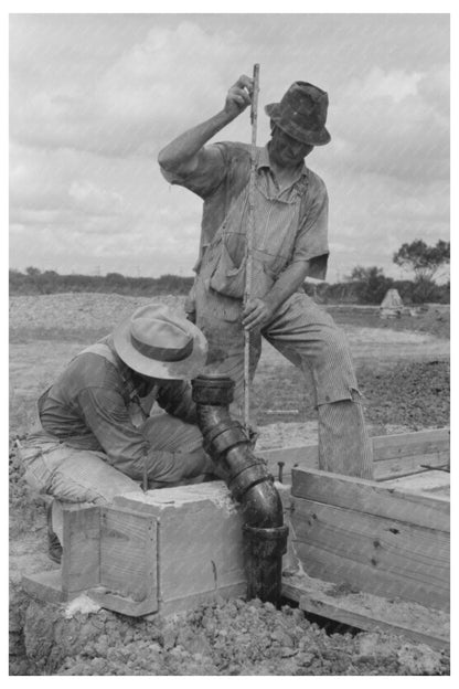 Workman Measuring at Migrant Labor Camp Sinton Texas 1939