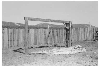 Faro Caudill erects tent support Pie Town New Mexico 1940