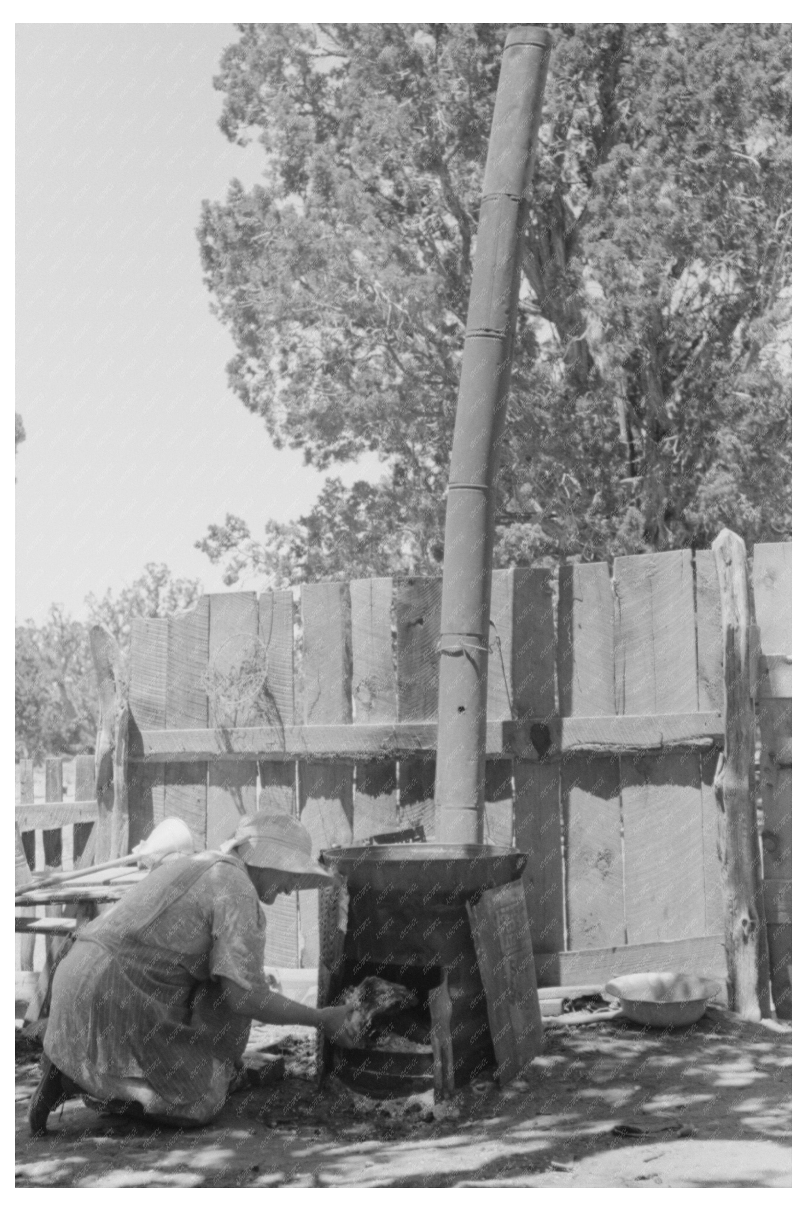 Mrs. Hutton Heats Water in Pie Town New Mexico June 1940