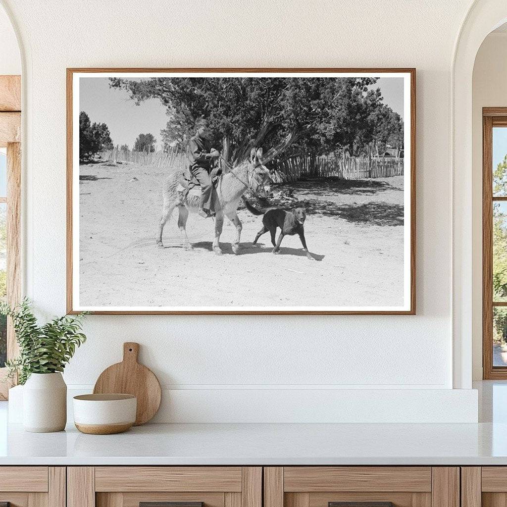 Young Hutton with Dog and Burro Leading Cows Pie Town 1940