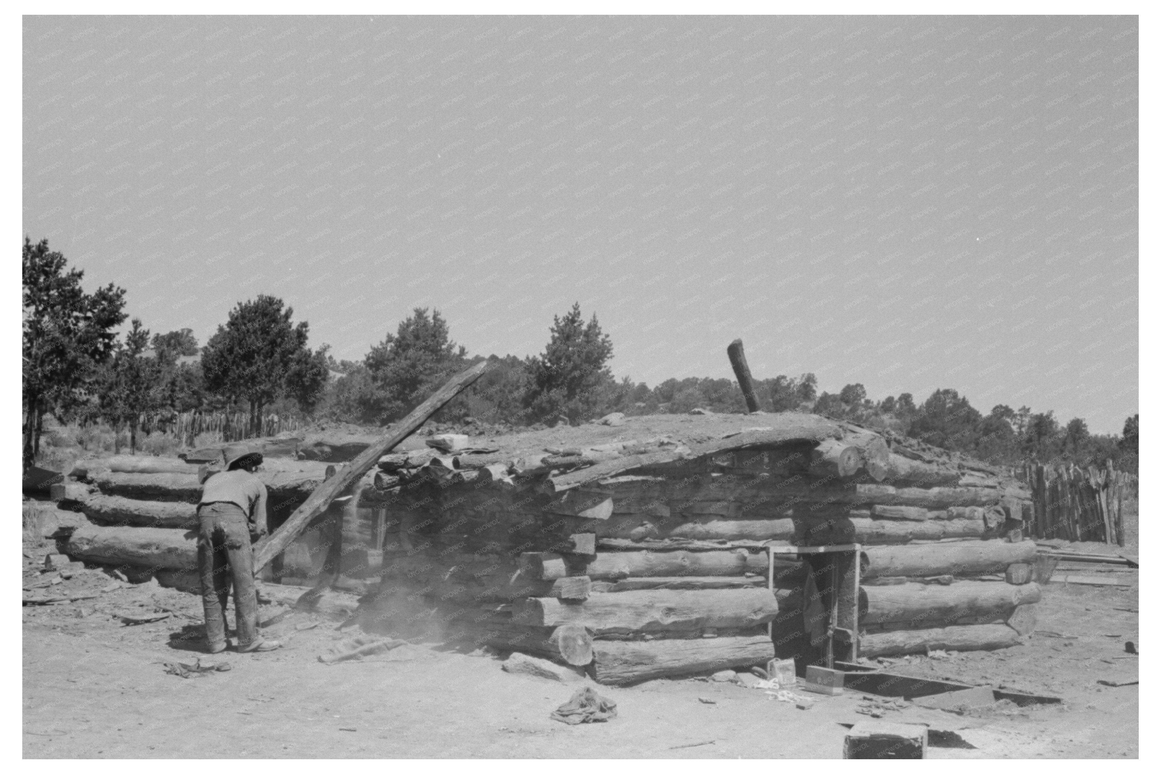 John Adams Stacking Pinon Poles in Pie Town 1940