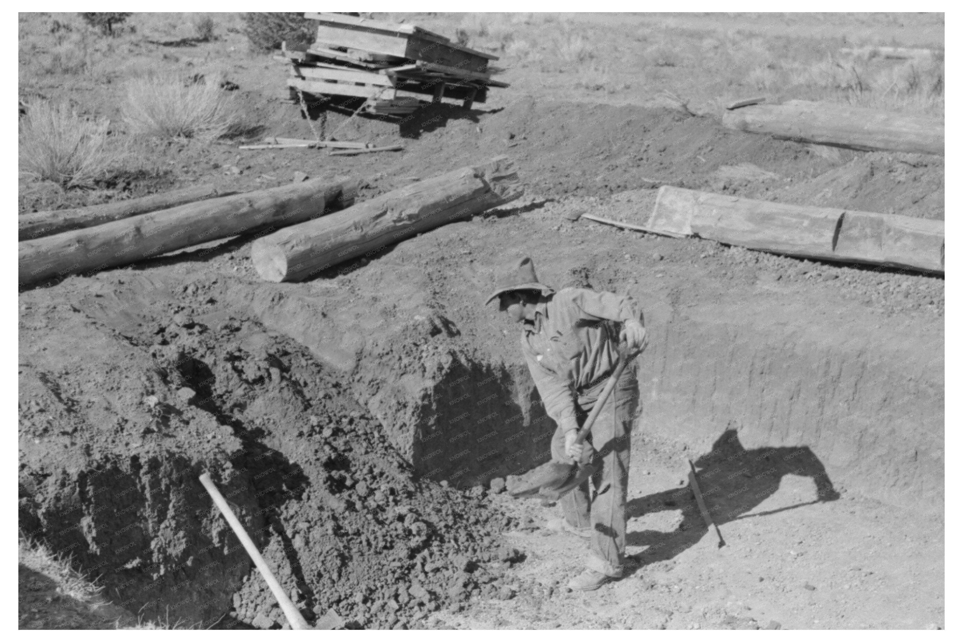 Faro Caudill Shoveling Dirt in Pie Town New Mexico 1940