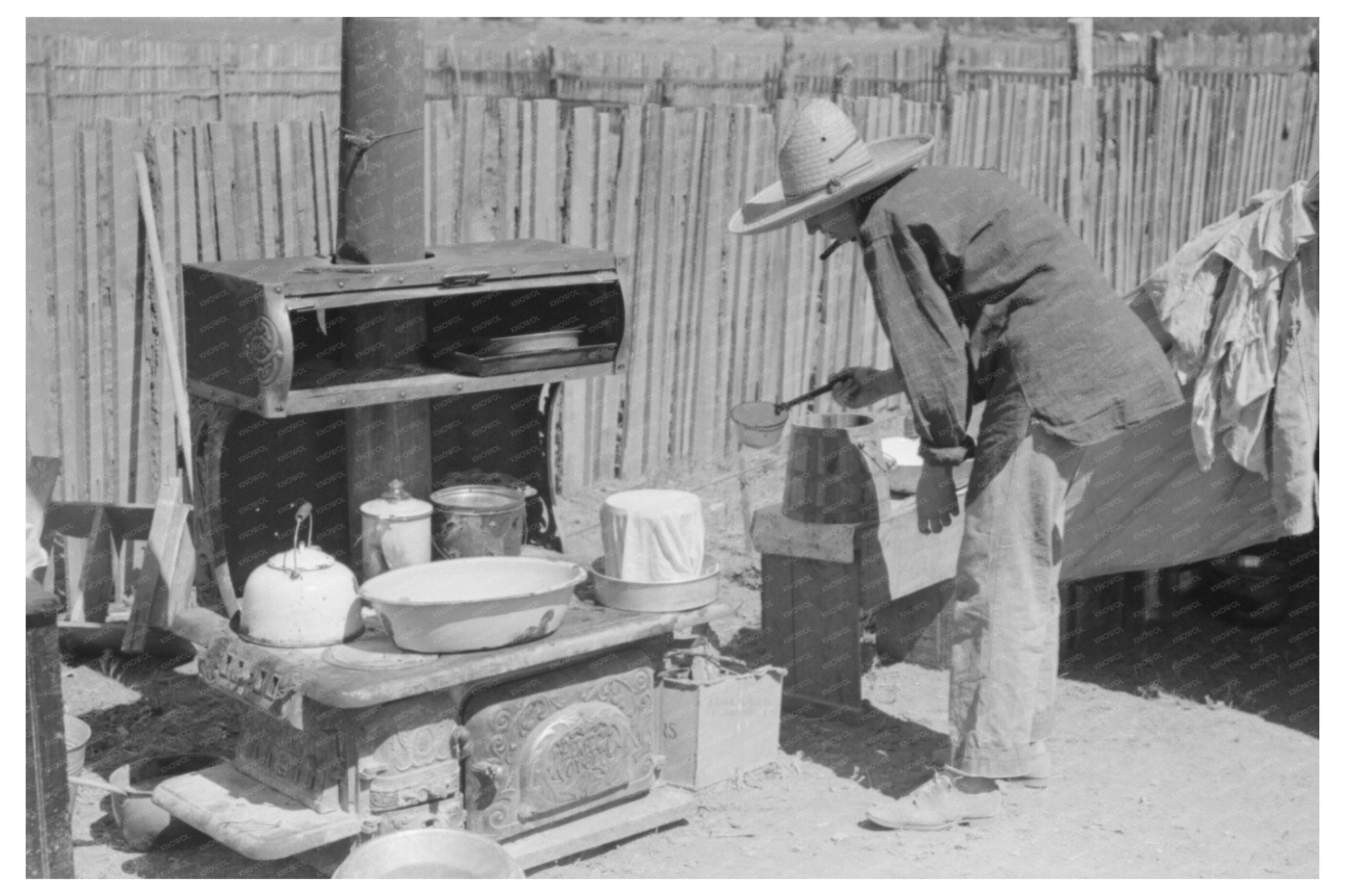 Mrs. Faro Caudill Pouring Water Over Milk Bucket 1940