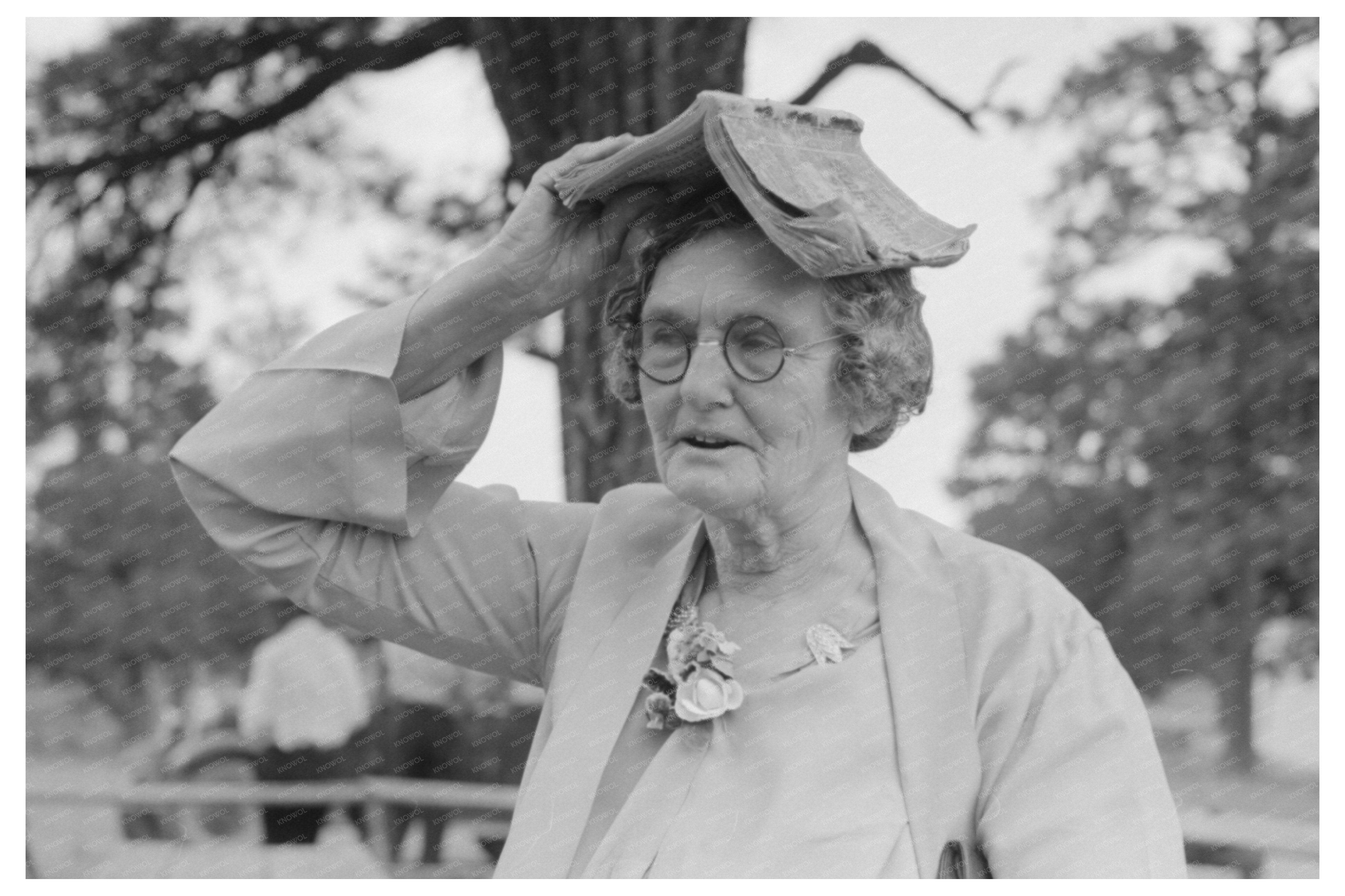 Farm Woman Using Songbook as Sunshade in Pie Town 1940