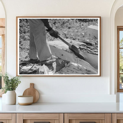 Worker in Pie Town New Mexico cutting log for railroad tie 1940