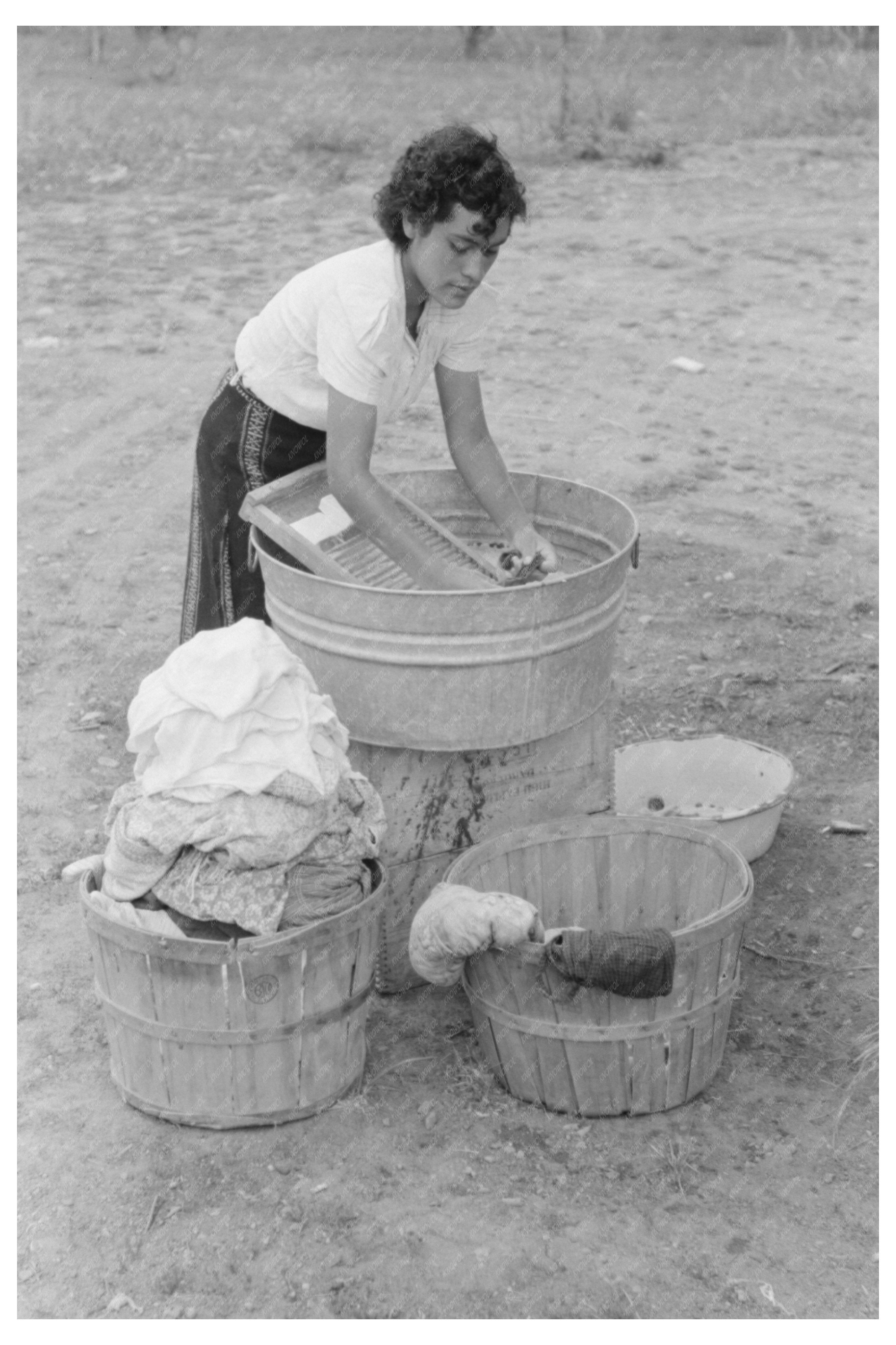 Daughter of Farmer Washing Clothes Chamisal New Mexico 1940