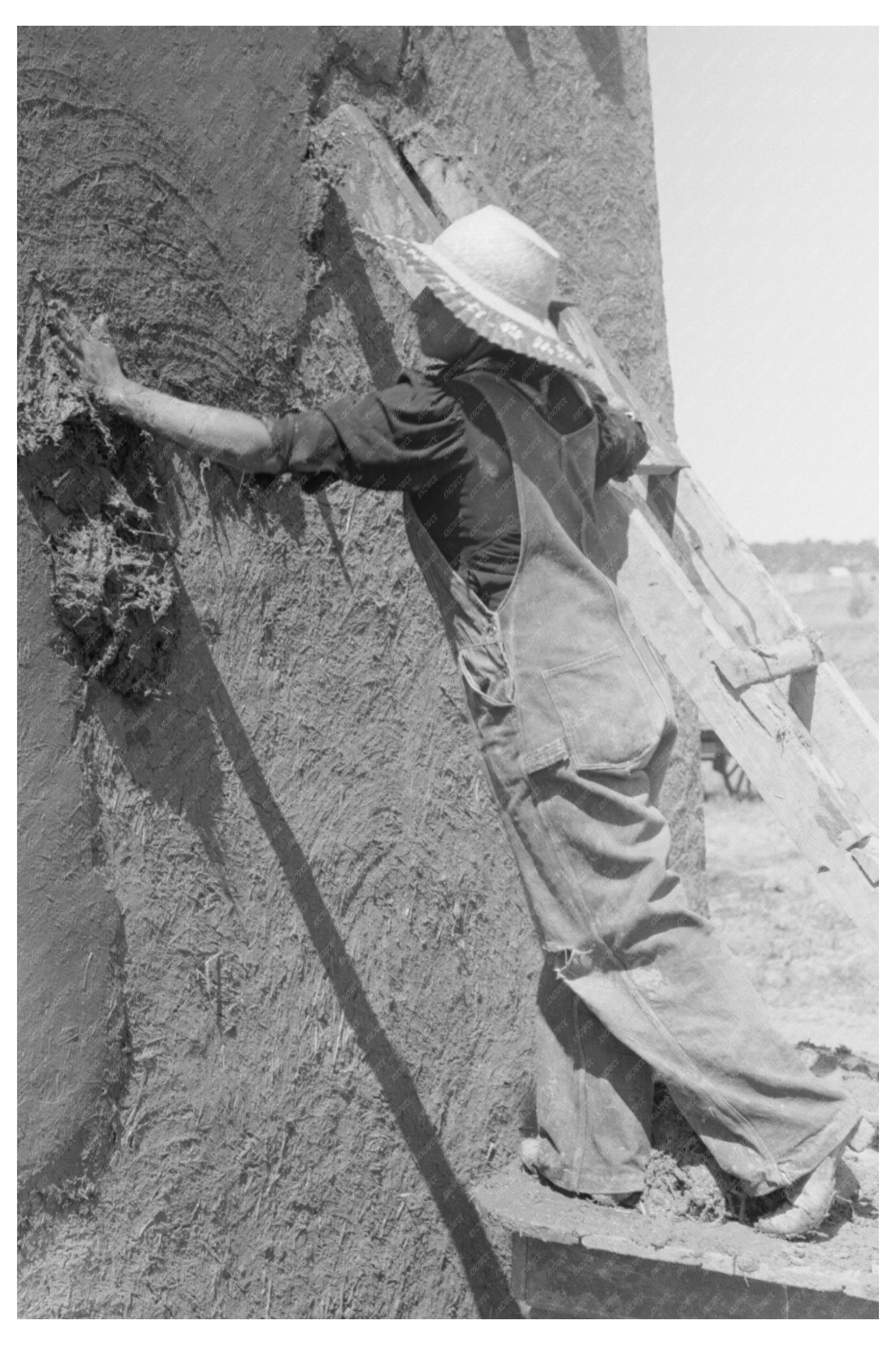 Spanish-American Woman Plastering Adobe House July 1940