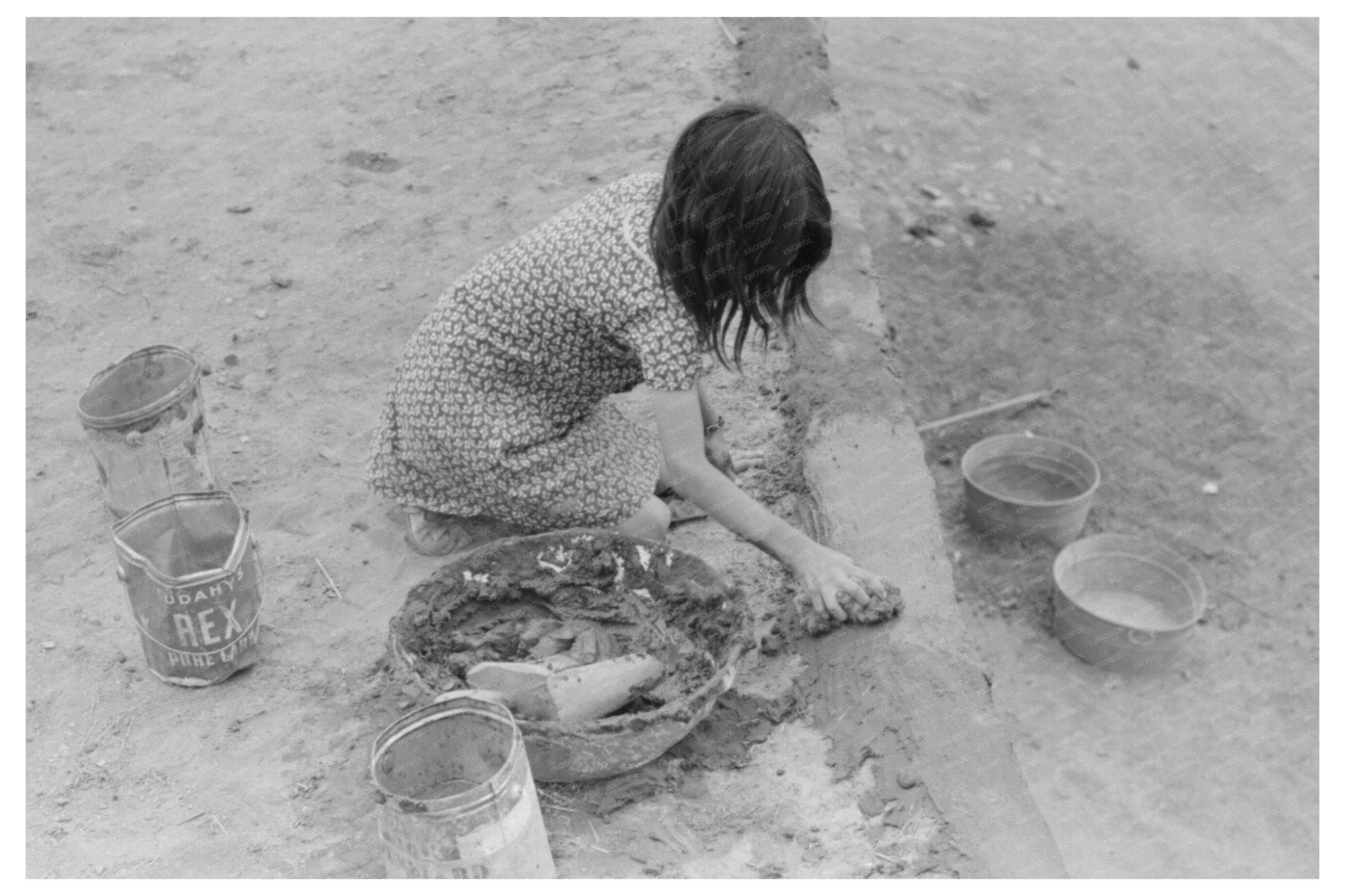 Smoothing Adobe Plaster in Costilla New Mexico 1940