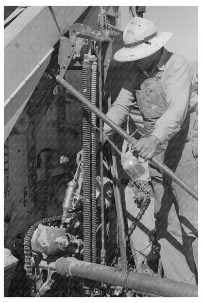 Worker Greasing Machinery at Farm Cooperative Utah 1940