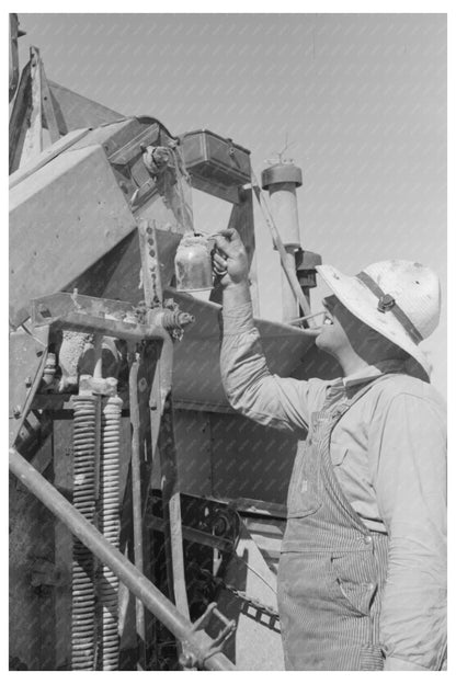 Farm Security Administration Worker Greasing Machinery 1940