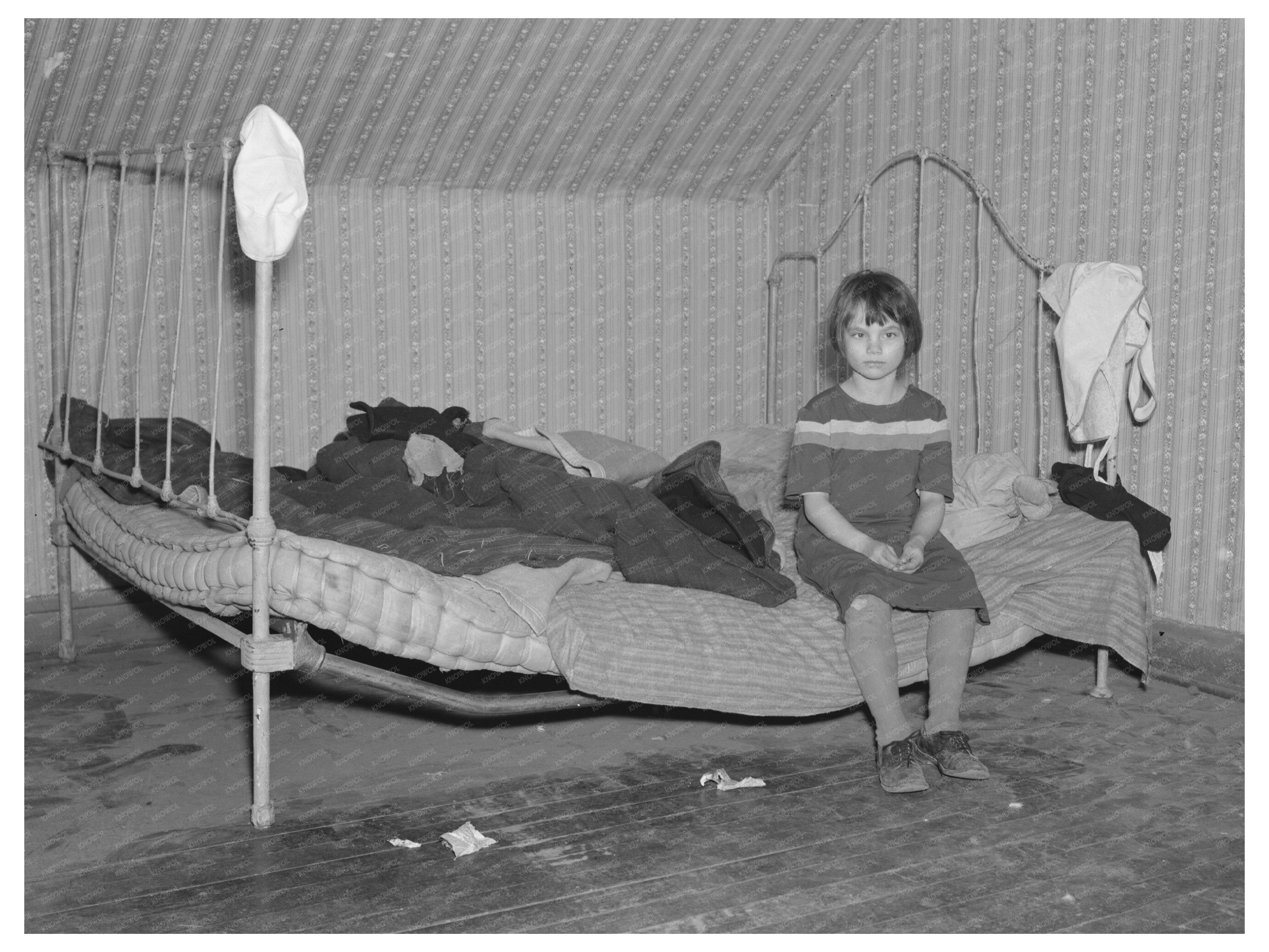 Child on Bed in Farmhouse Milford Iowa December 1936