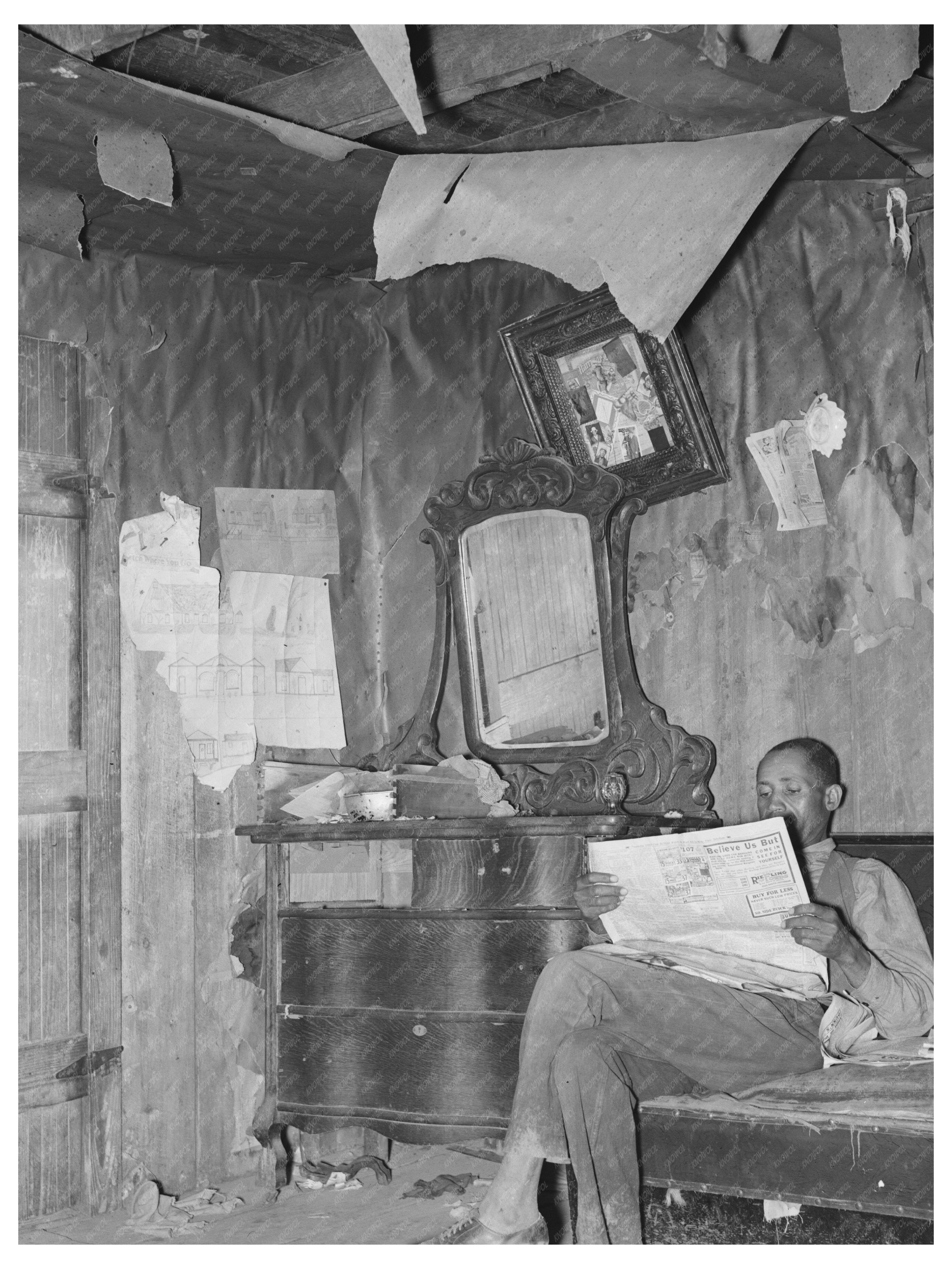 Sharecropper Reading Newspaper in Southeast Missouri 1938