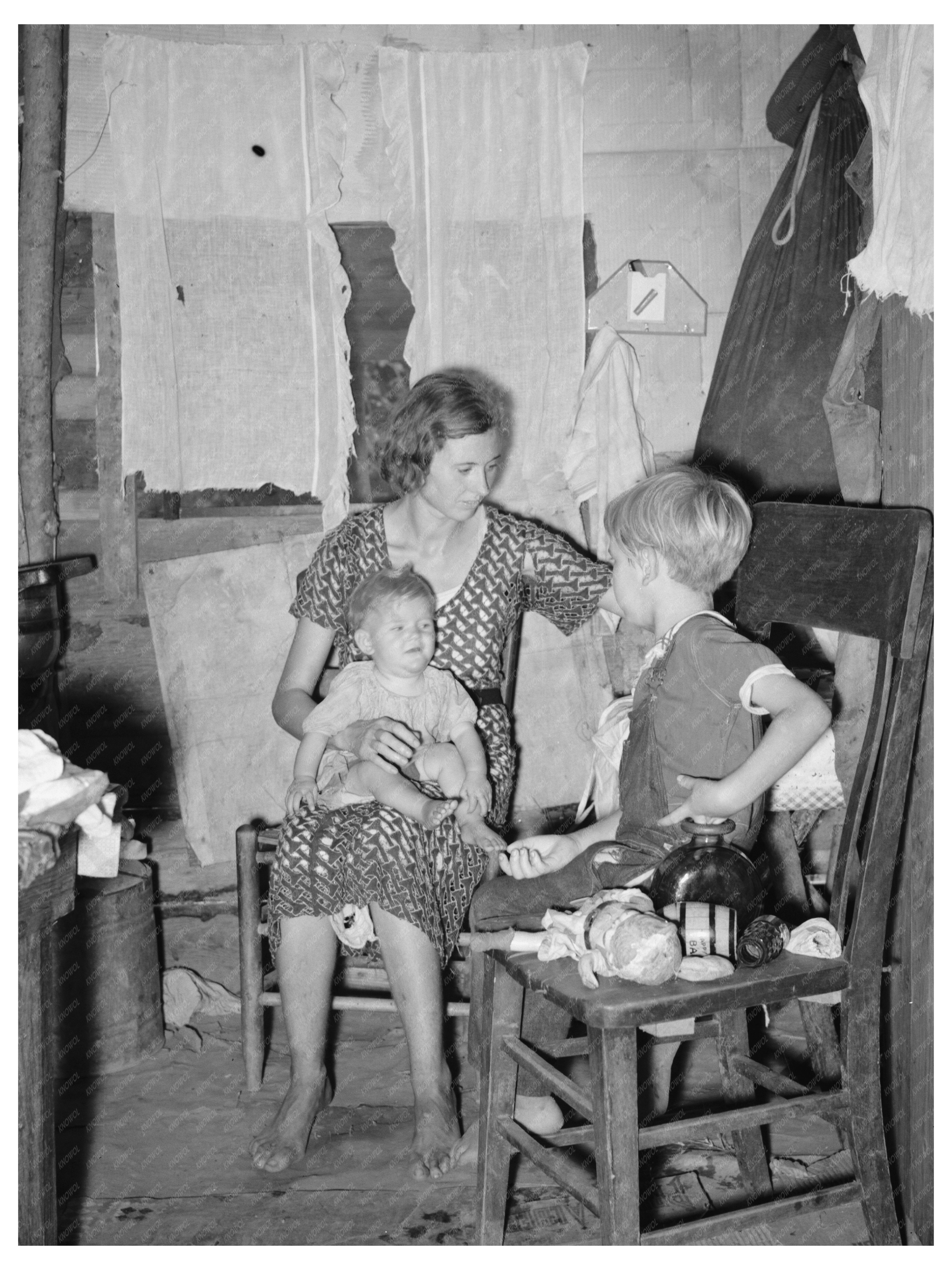 Young Girl Tending Fire in Tin Town Missouri 1938