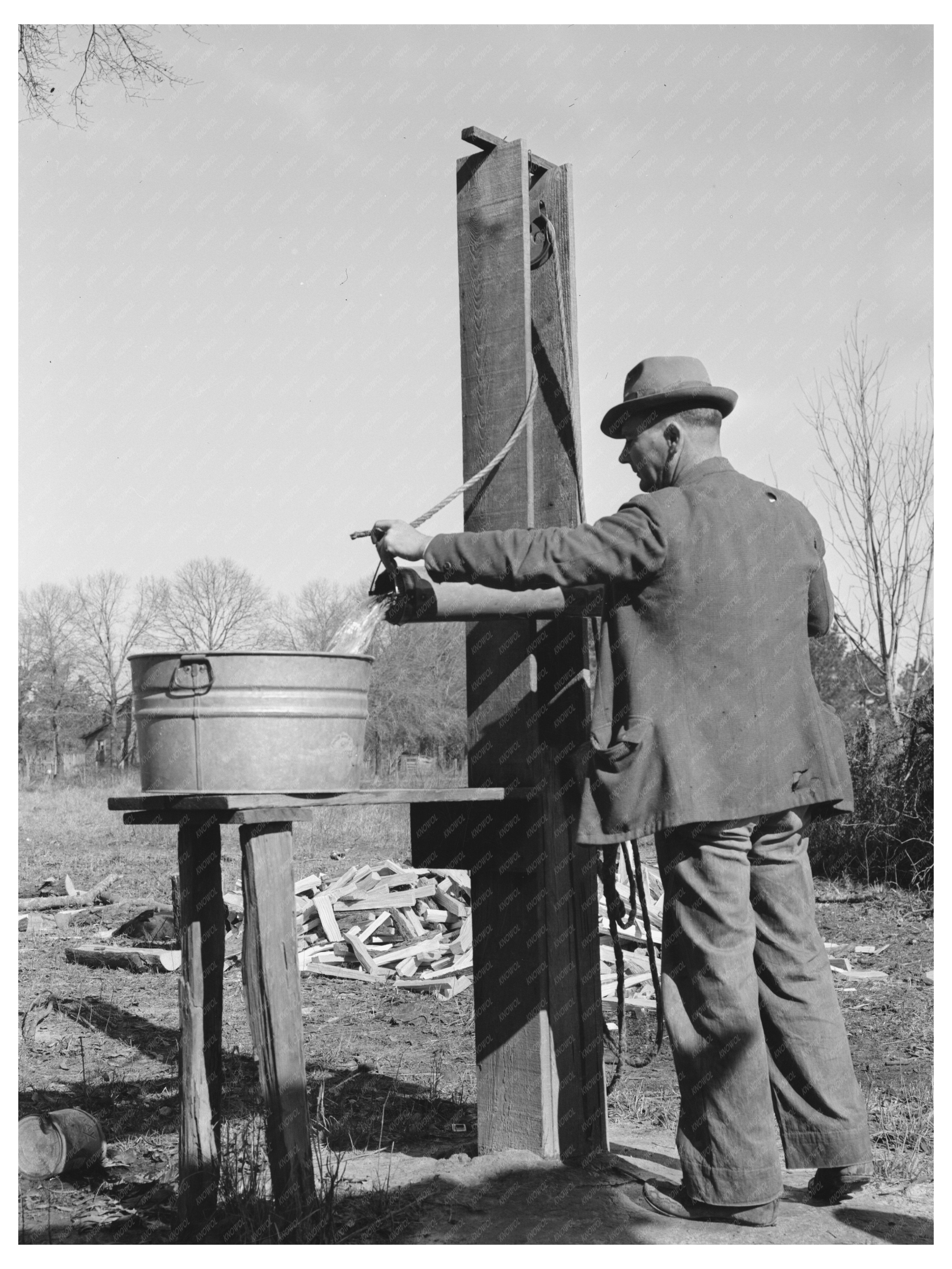 Ed Bagget Drawing Water at Well Laurel Mississippi 1939