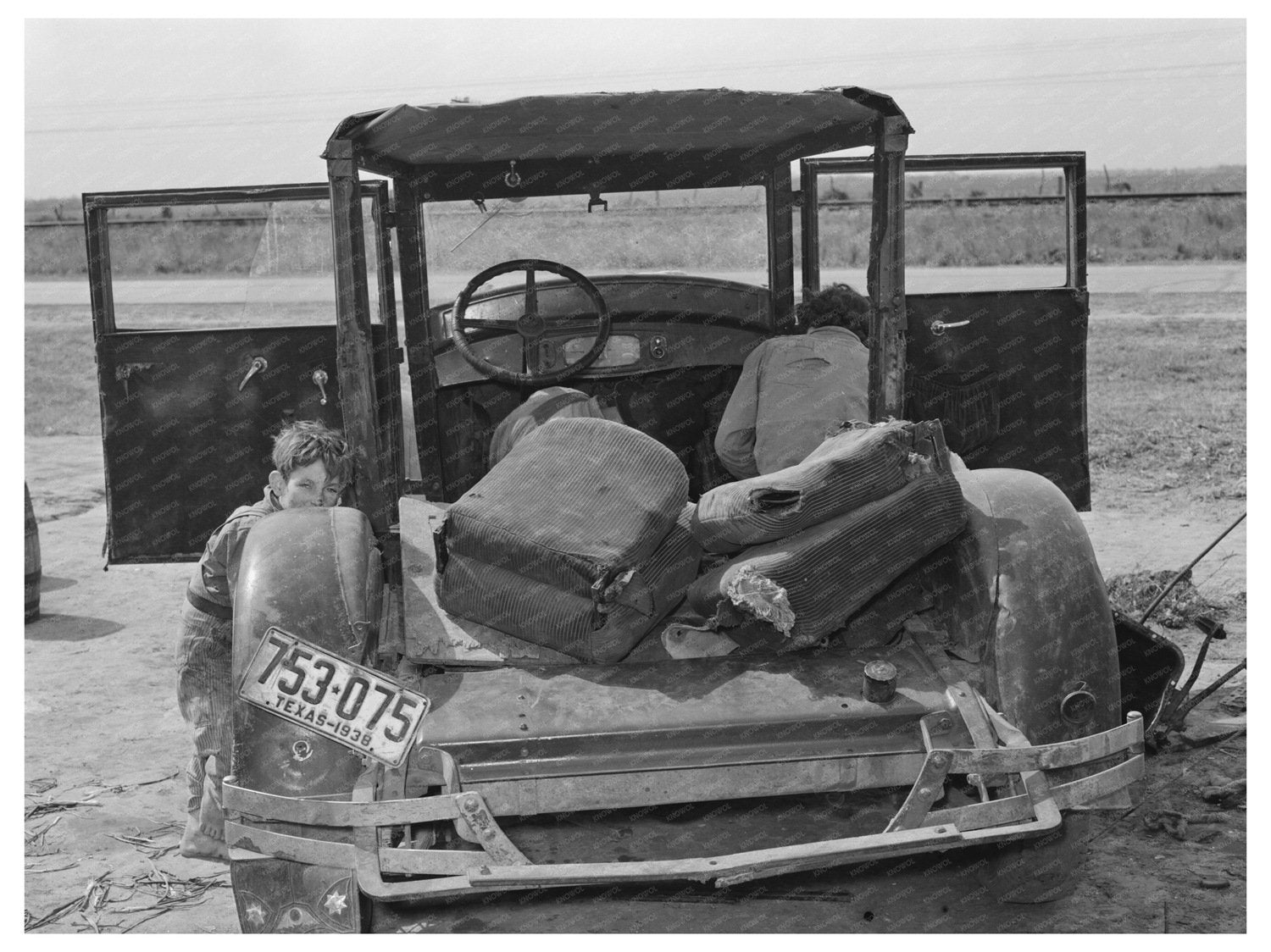Migrant Worker Repairs Car in Harlingen Texas 1939