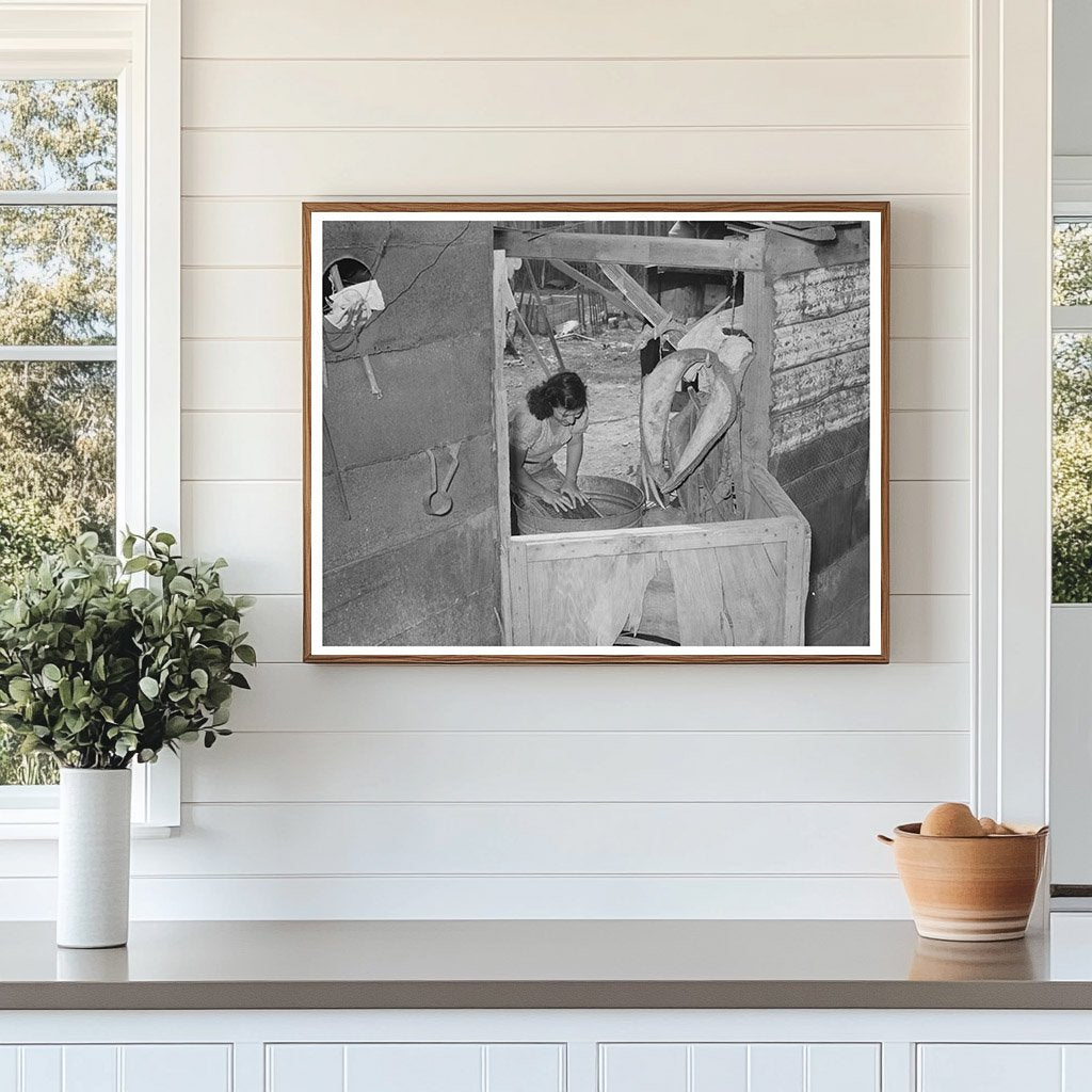 Mexican woman washing clothes in back of house. Sa