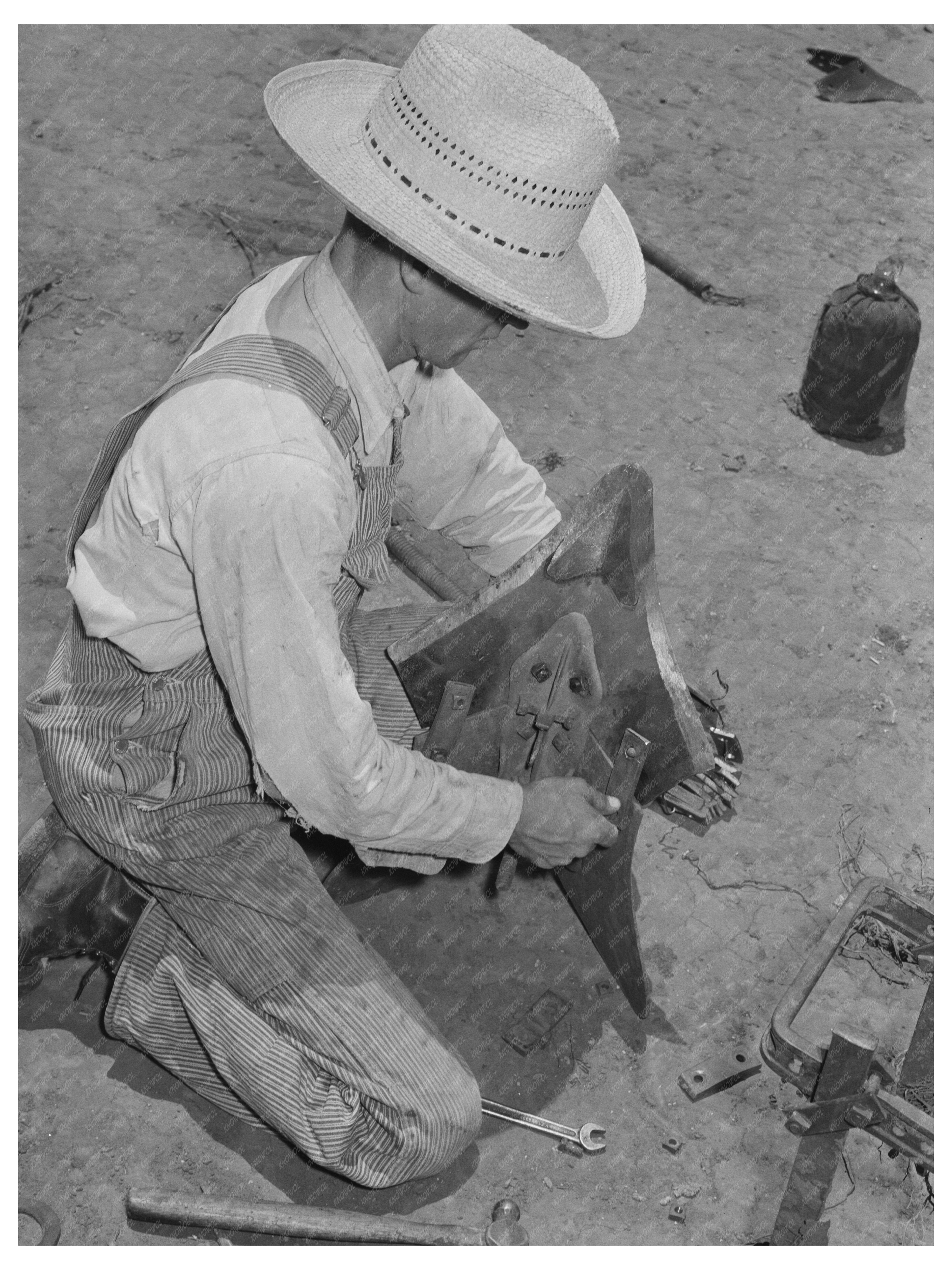 Laborer Adjusting Plow Point on Tractor Texas 1939