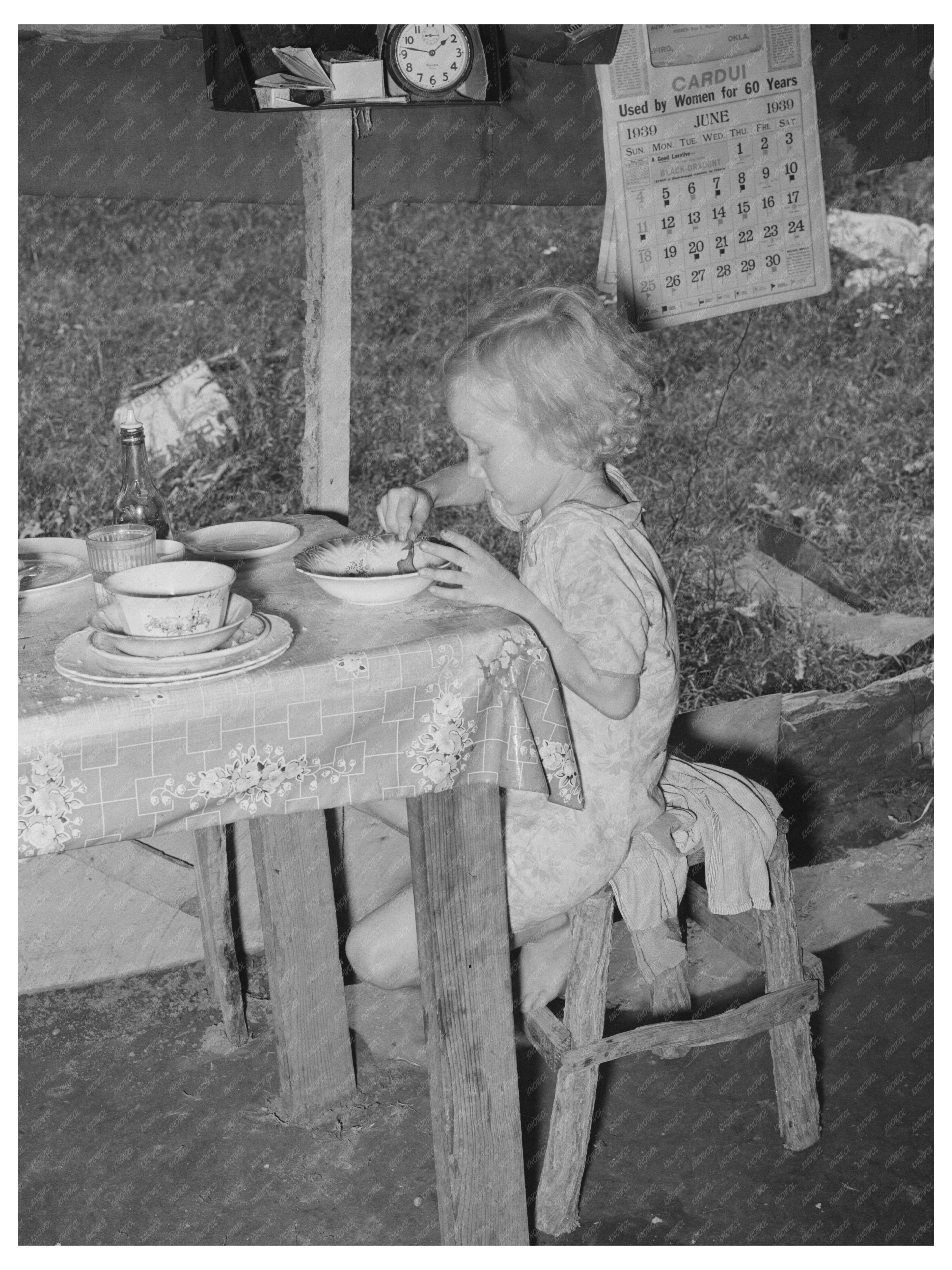 Daughter of Day Laborer Lunching in Tent Home 1939