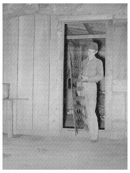 Migrant Boy Packing Bed in Muskogee Oklahoma 1939