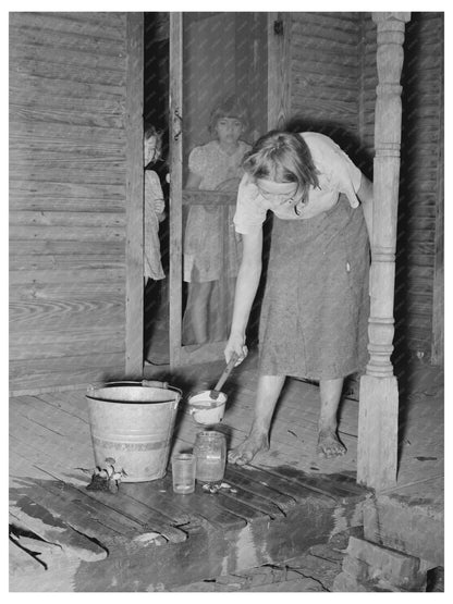 Daughter of Tenant Farmer Changing Goldfish Bowl 1939