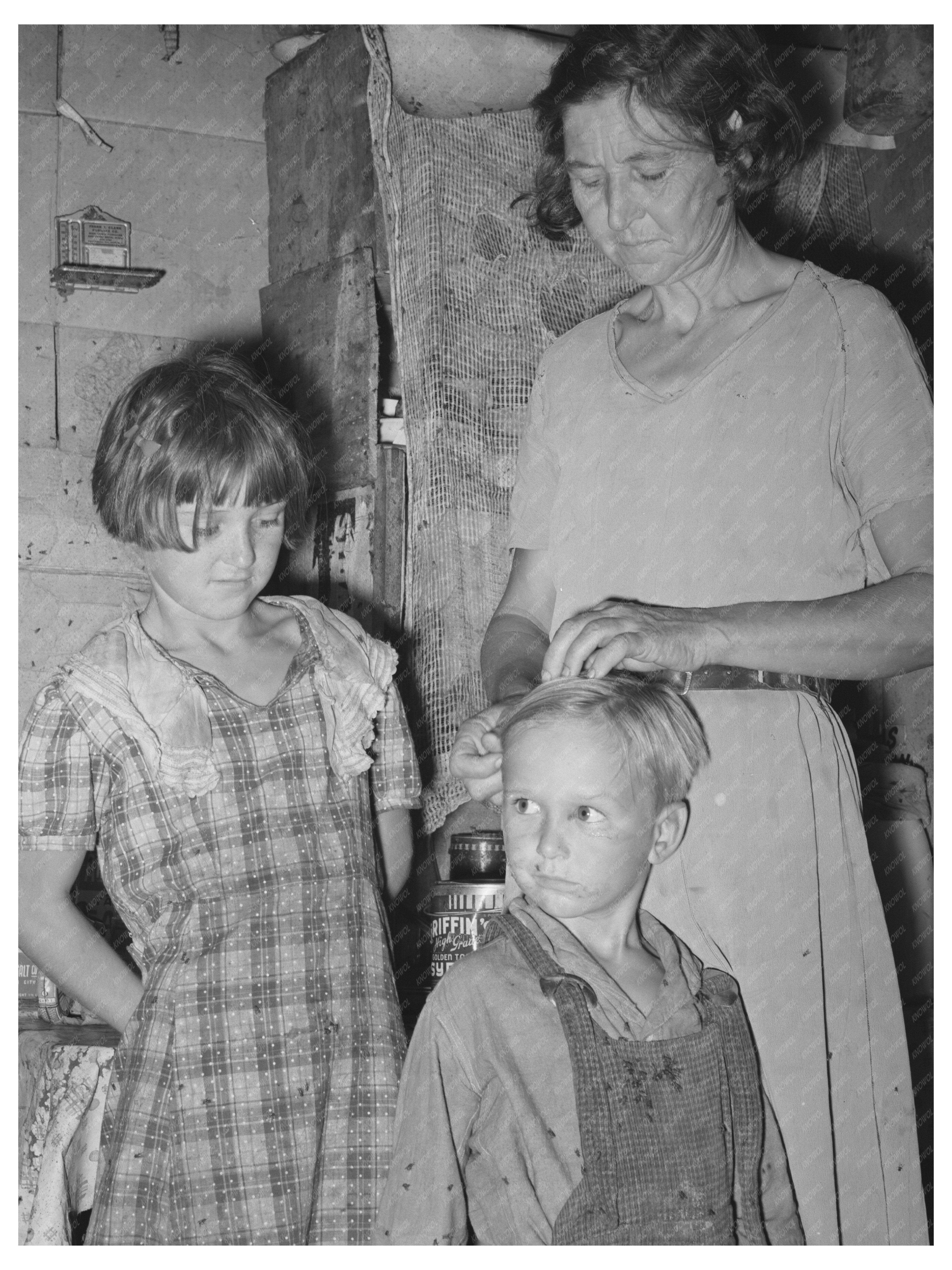 Mother Adjusts Sons Hair in Oklahoma City Camp 1939