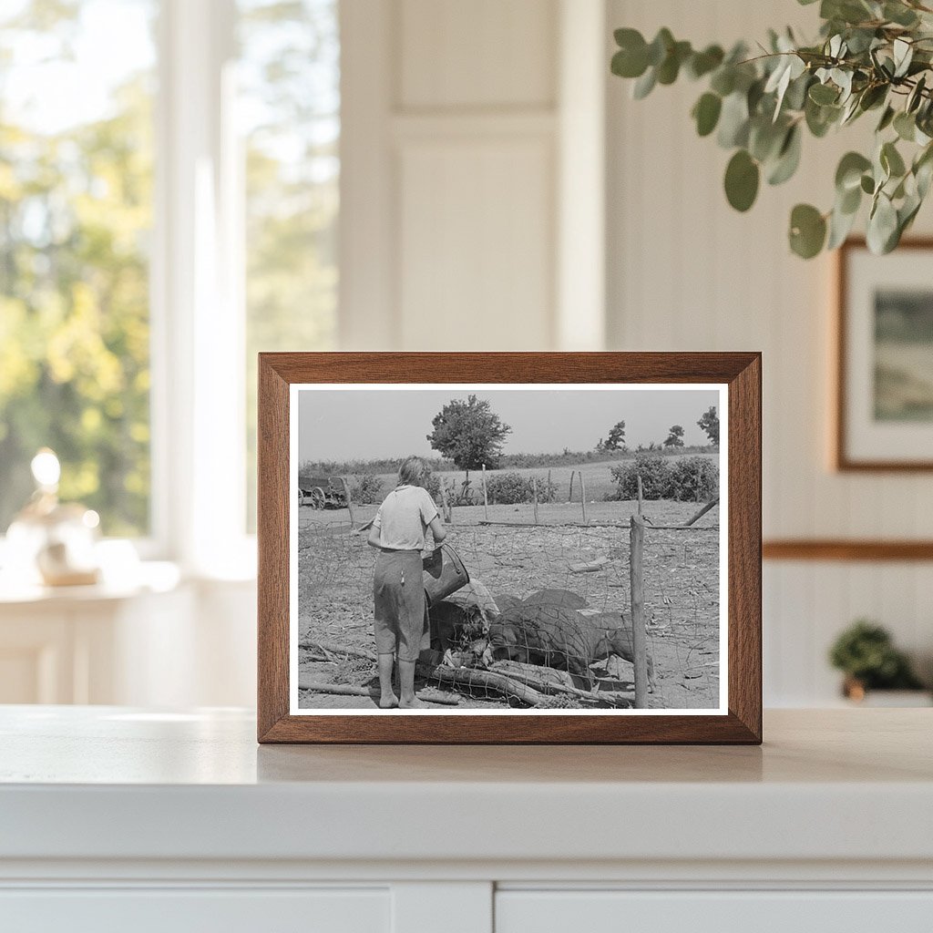 Daughter of Tenant Farmer Feeding Hogs Muskogee 1939