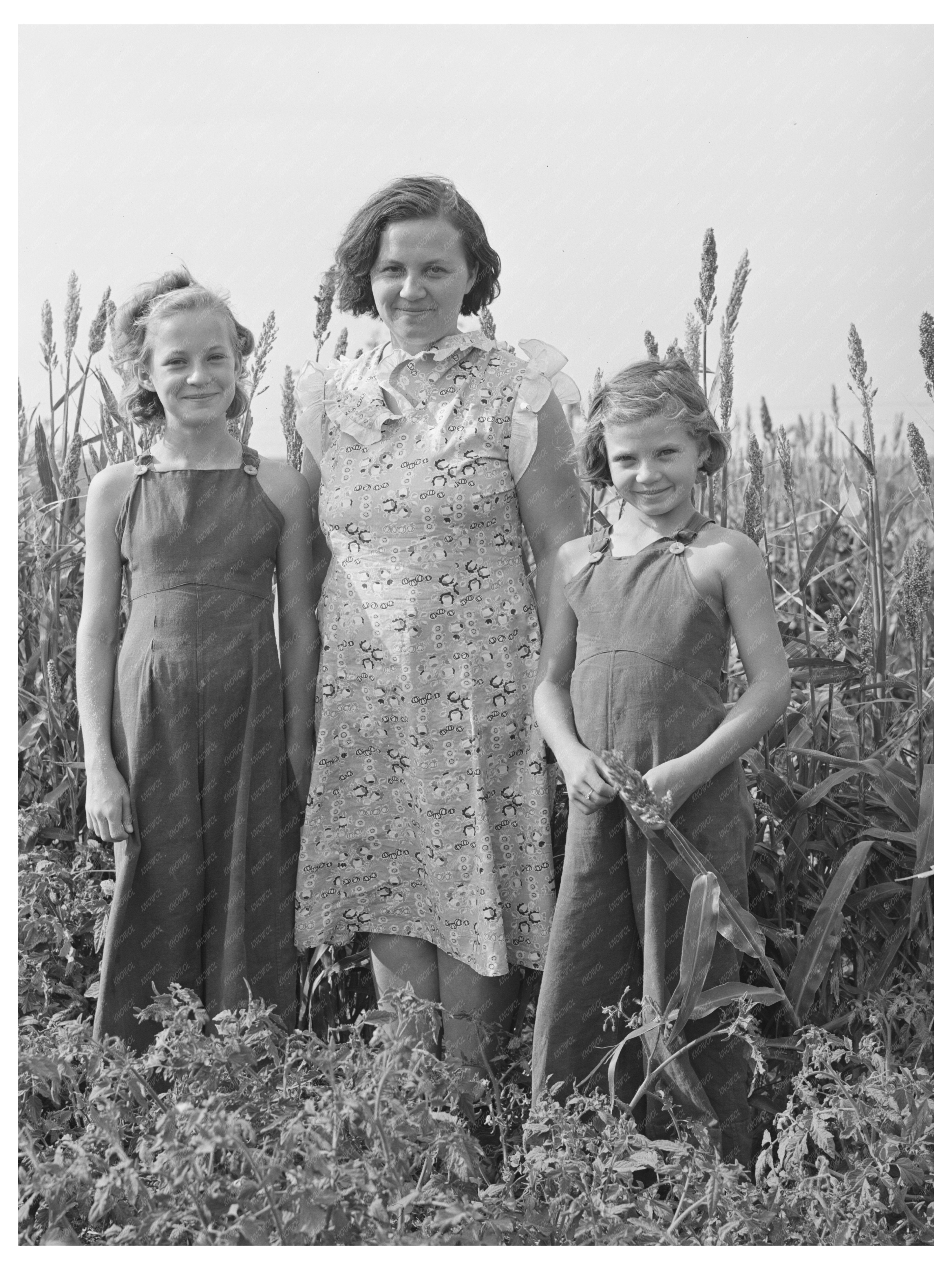 Woman and Daughters in Kansas Garden August 1939