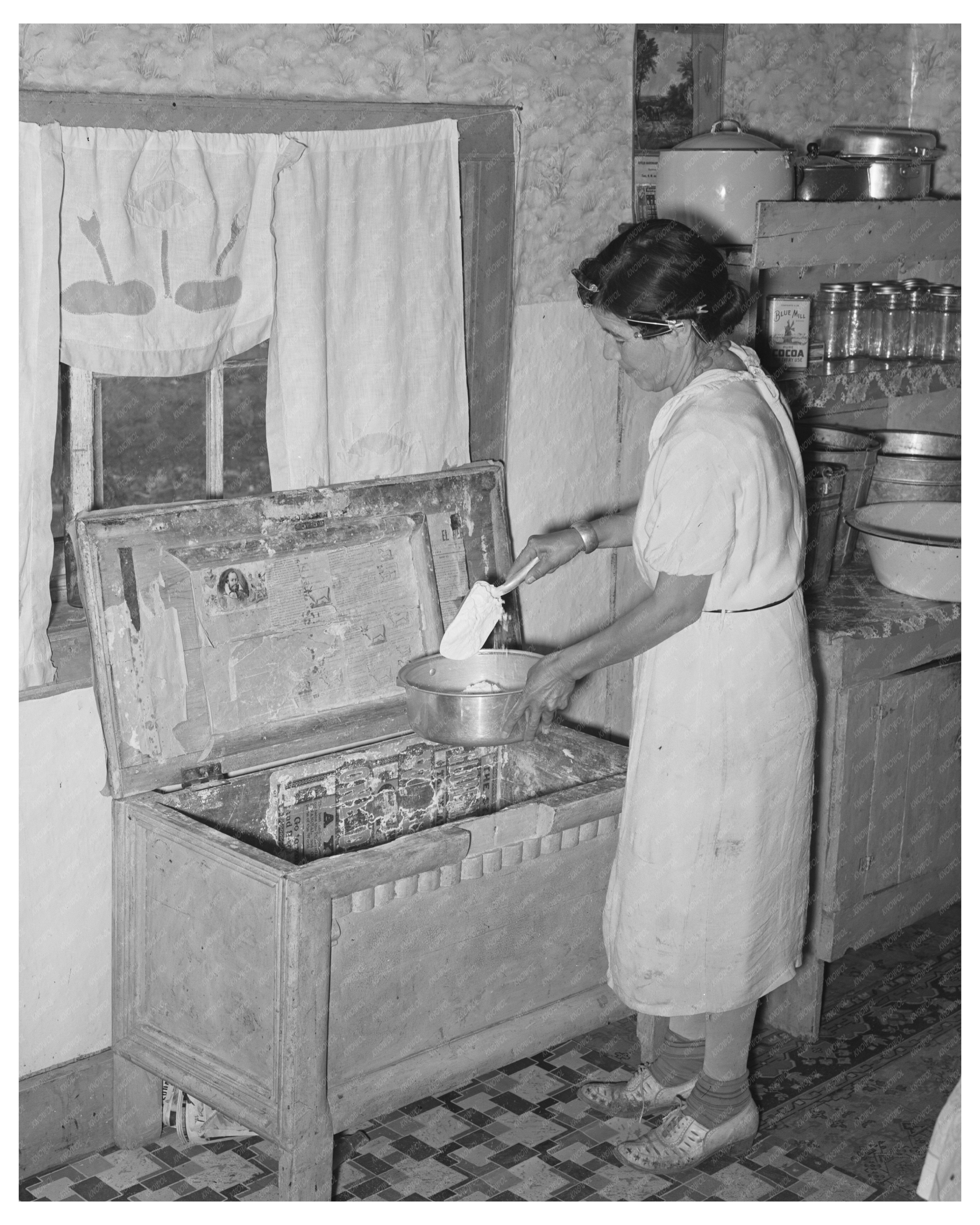 Spanish-American Woman Retrieving Flour in Taos 1939