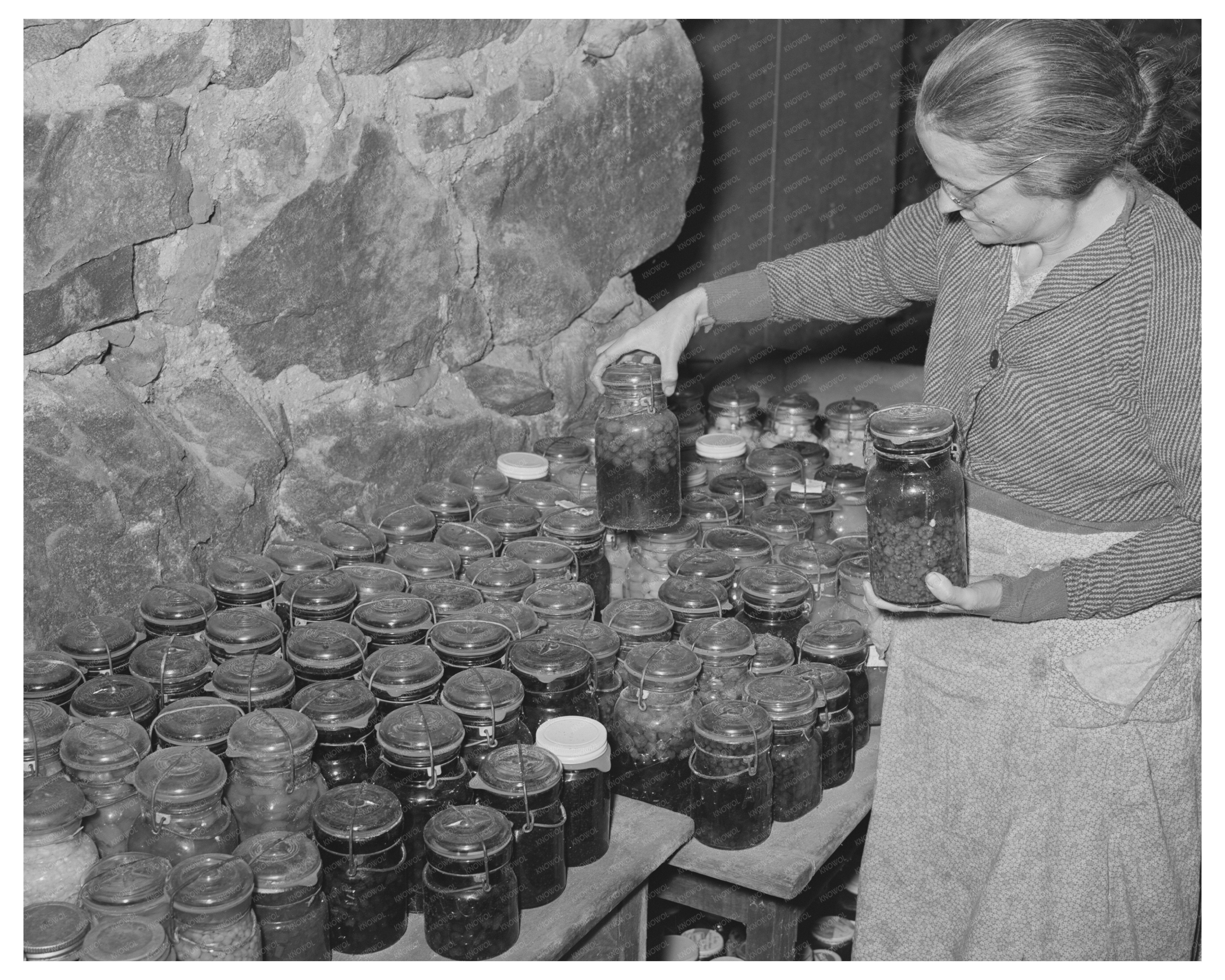 Woman Inspecting Canned Goods in Vermont Cellar 1939