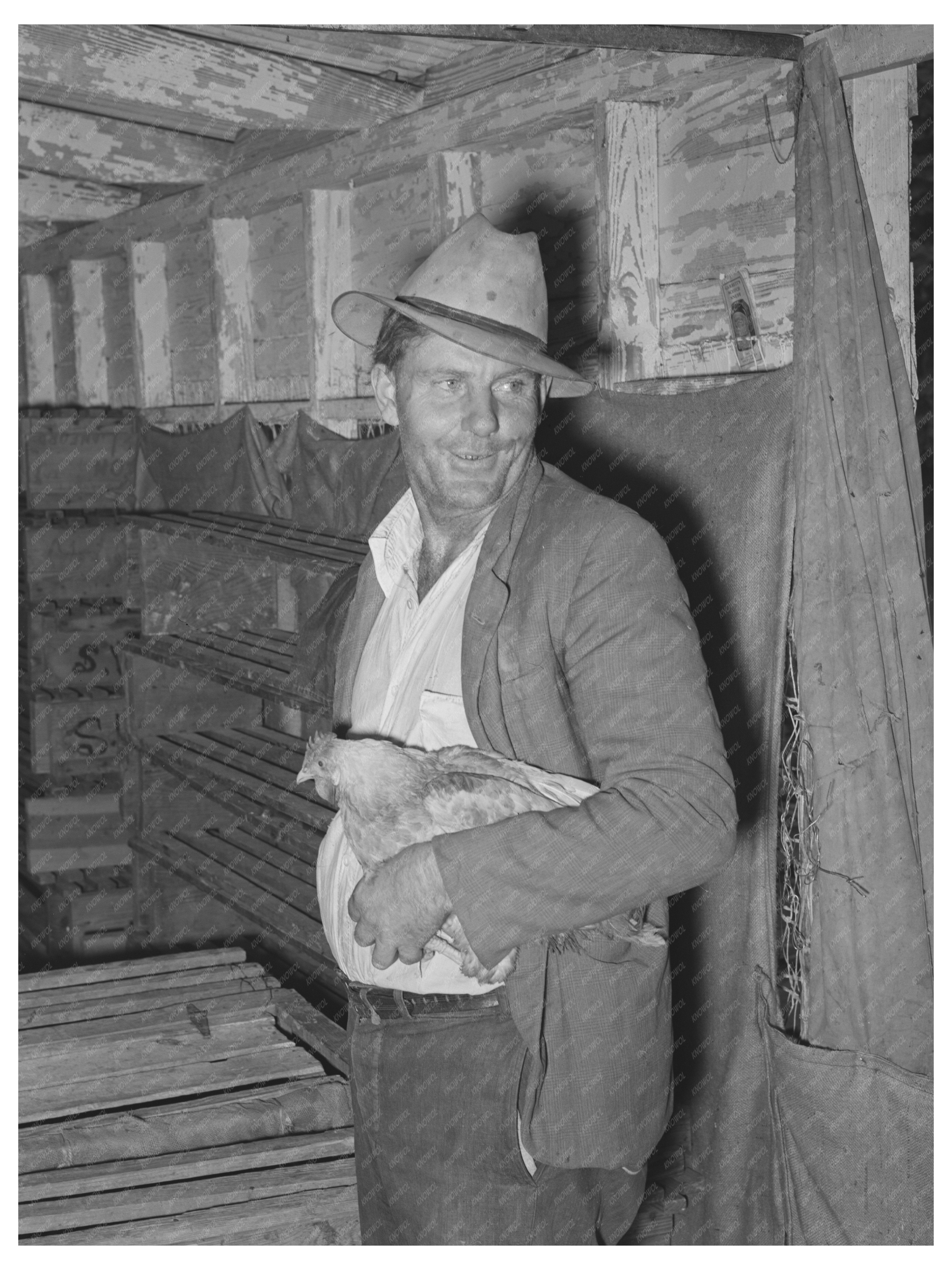 Man Holding Chicken at Brownwood Poultry House 1939