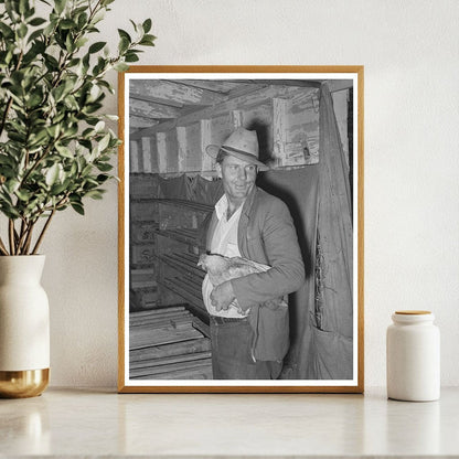 Man Holding Chicken at Brownwood Poultry House 1939