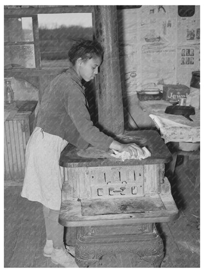 Daughter of Tenant Farmer Cleaning Stove Oklahoma 1940