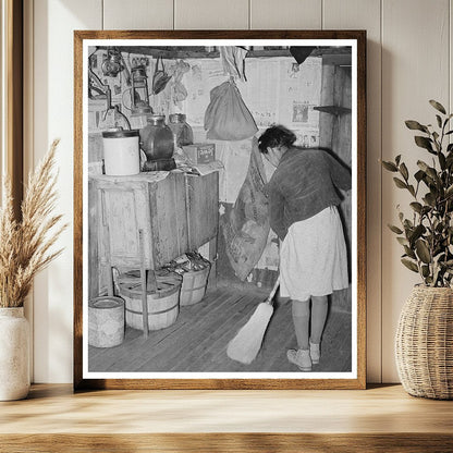Daughter of Tenant Farmer Sweeping Kitchen February 1944