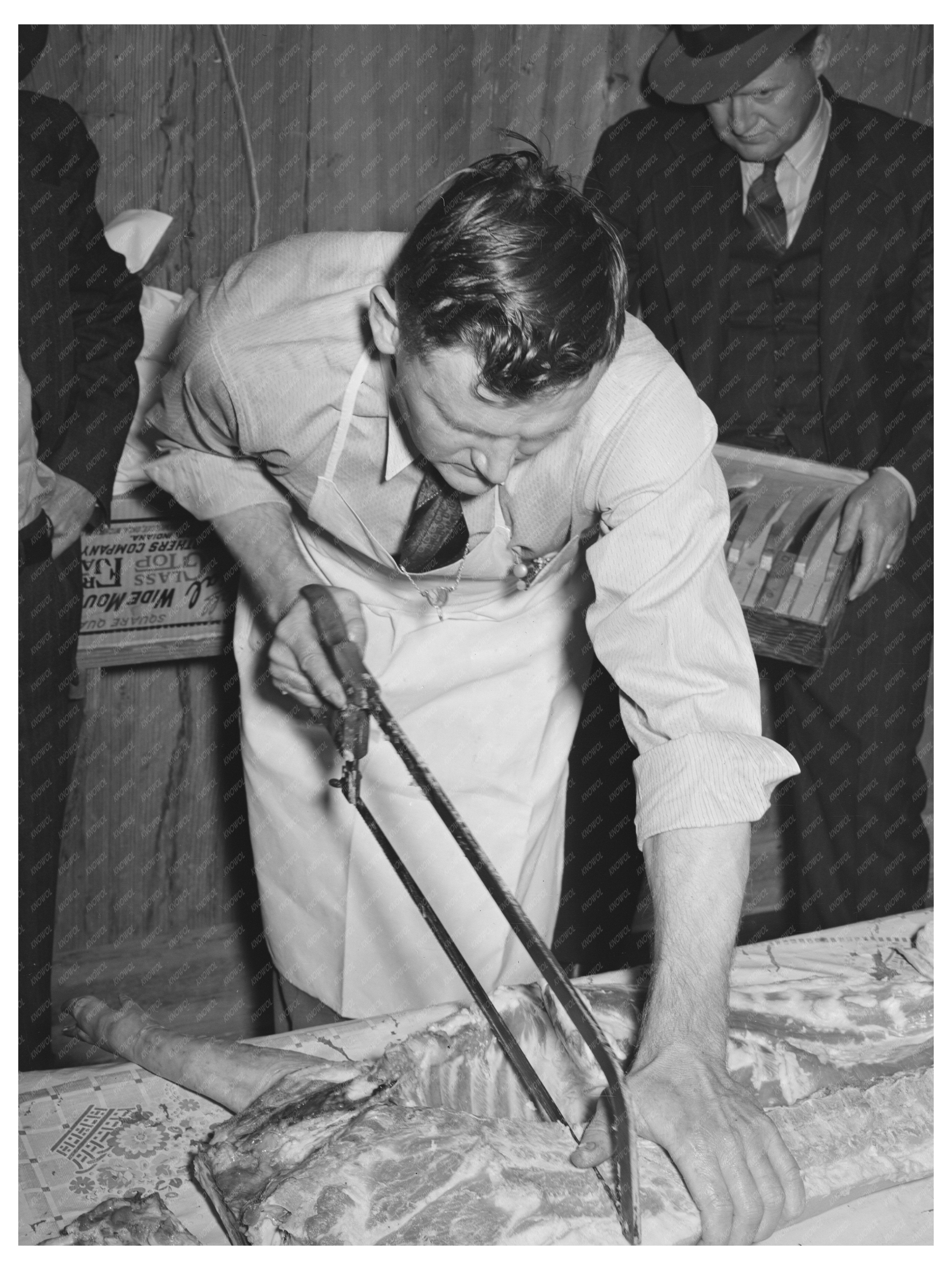 Farm Security Supervisor Teaches Meat Cutting Techniques 1940