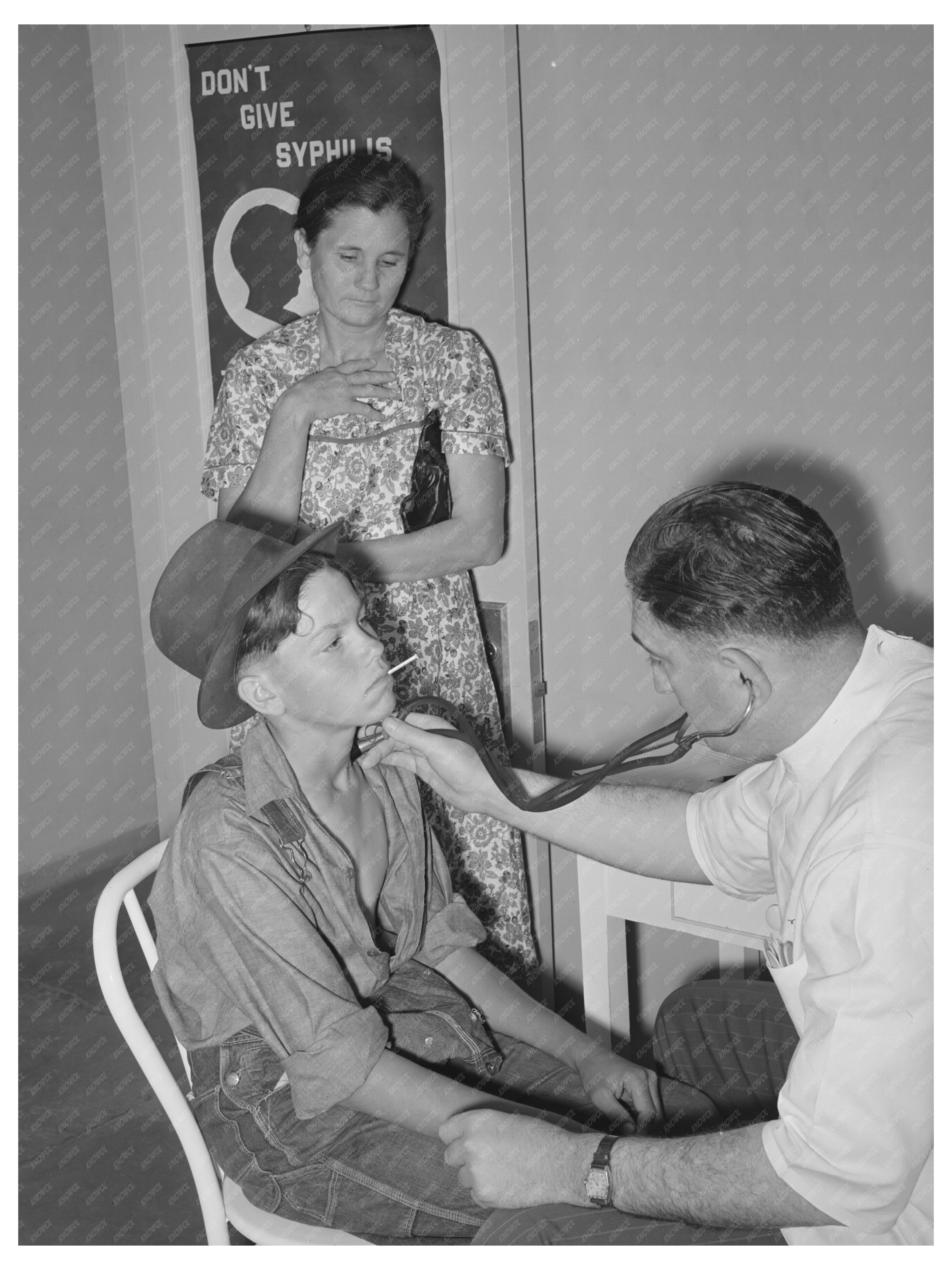 Doctor Examines Child at Agua Fria Camp May 1940