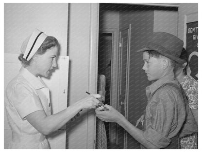 Nurse Instructs Migratory Laborers Son on Medication 1940