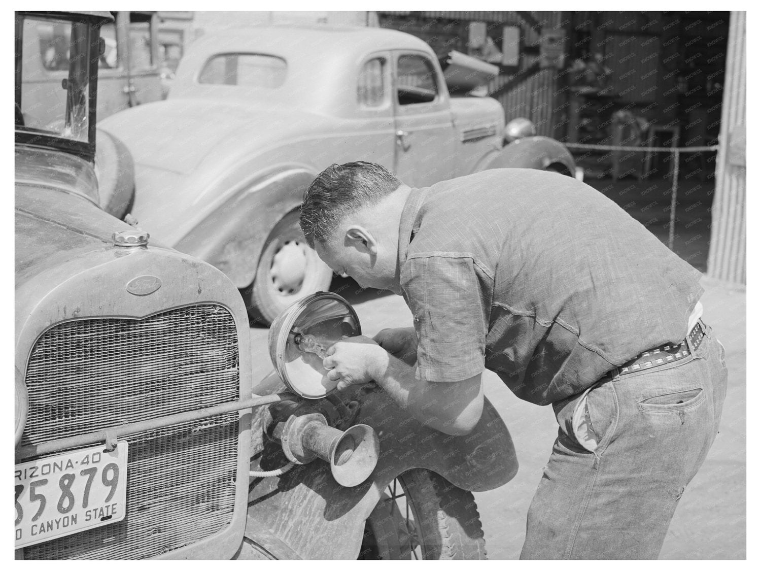Repairman Replaces Light Bulb in Phoenix 1940