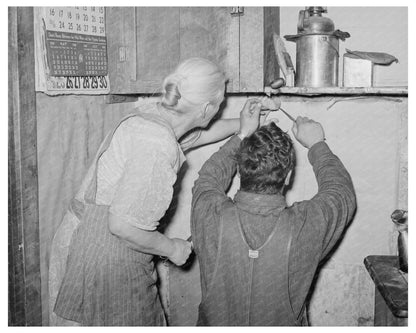 Mrs. Hutton and Son Papering Kitchen in Pie Town 1940