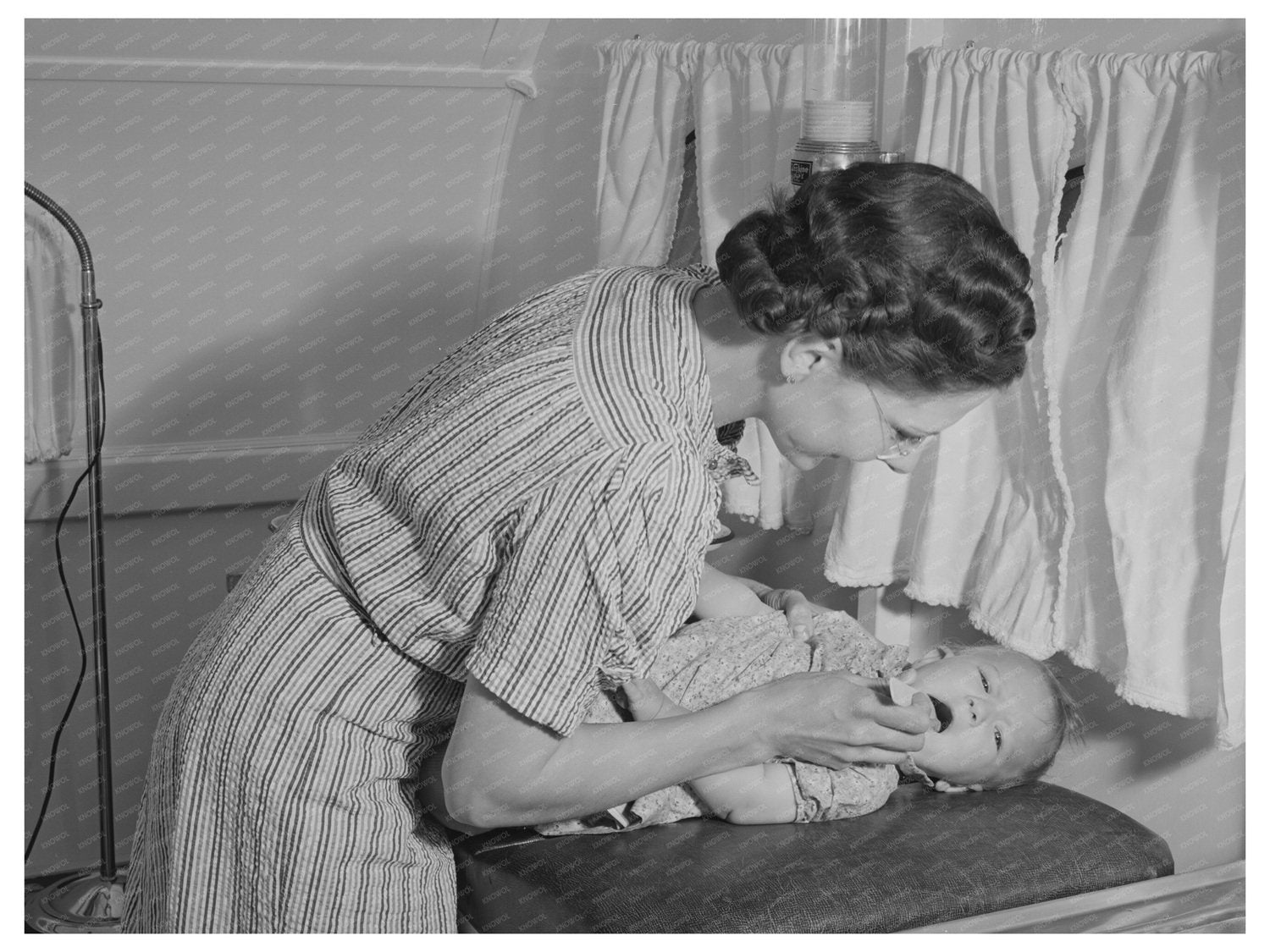 Nurse Examines Babys Throat in Idaho Mobile Clinic 1941
