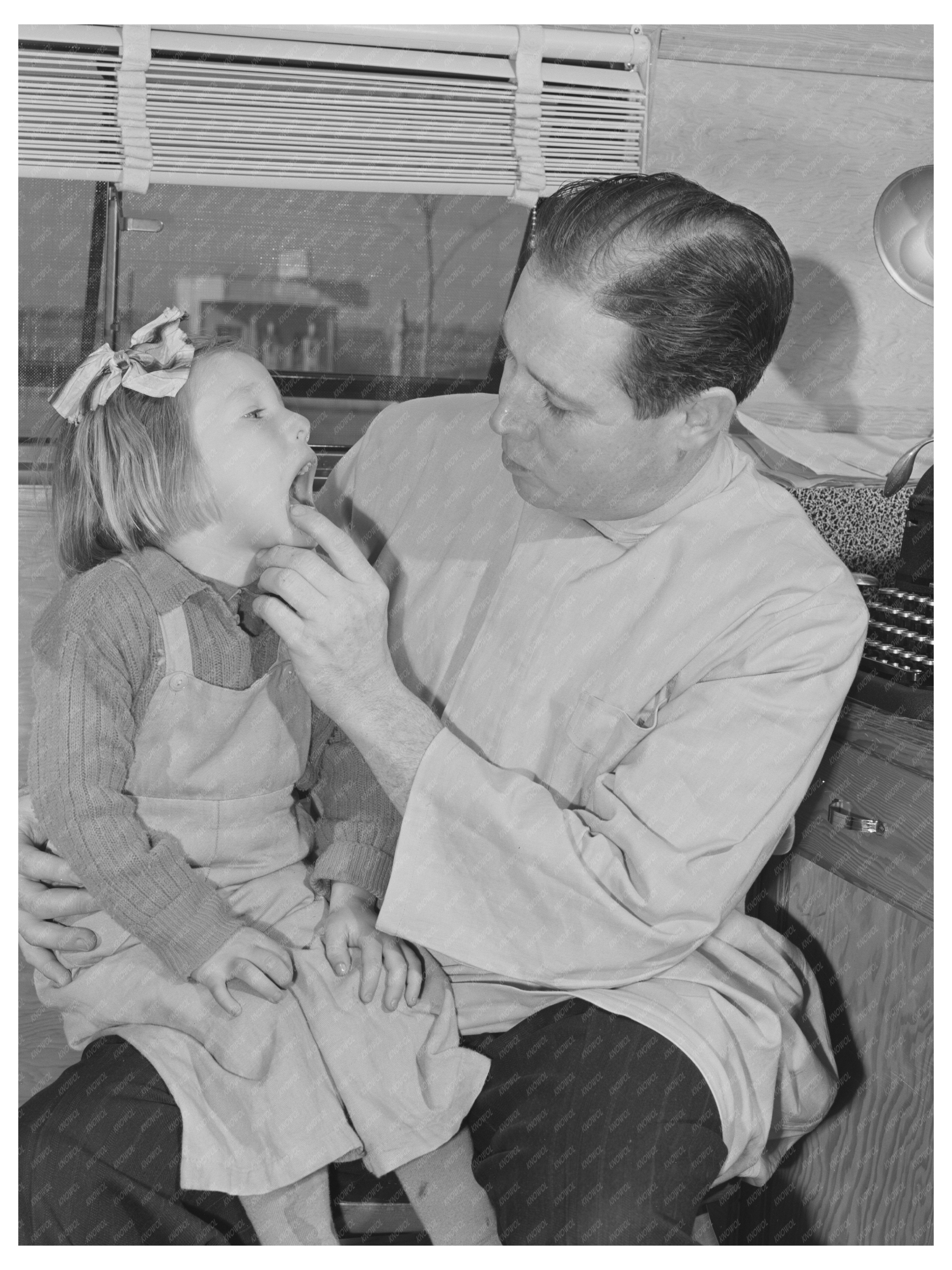 Dentist Examines Young Migrant Child in Idaho 1941