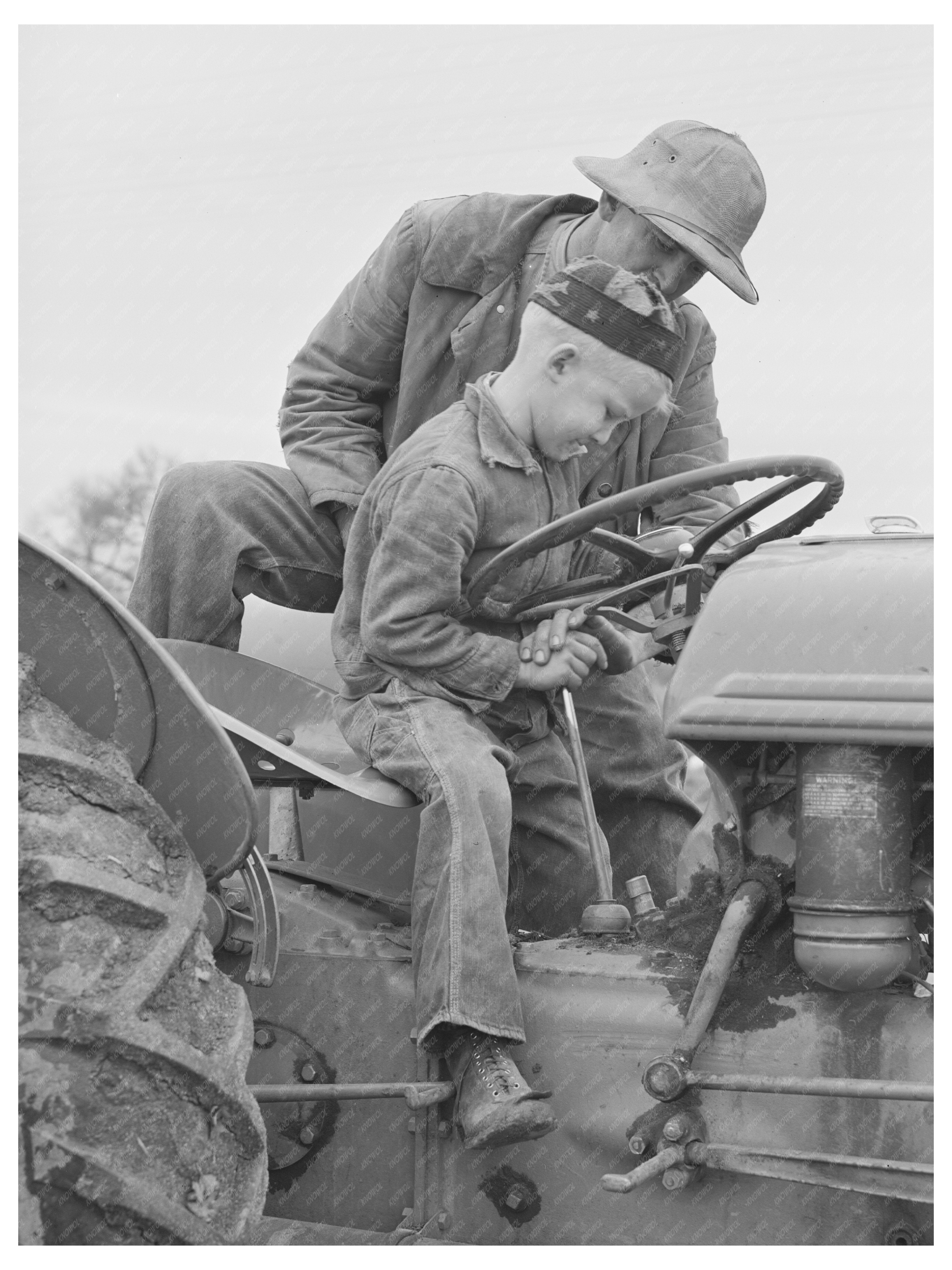 Farmer Teaching Son to Drive Tractor Tulare County 1942