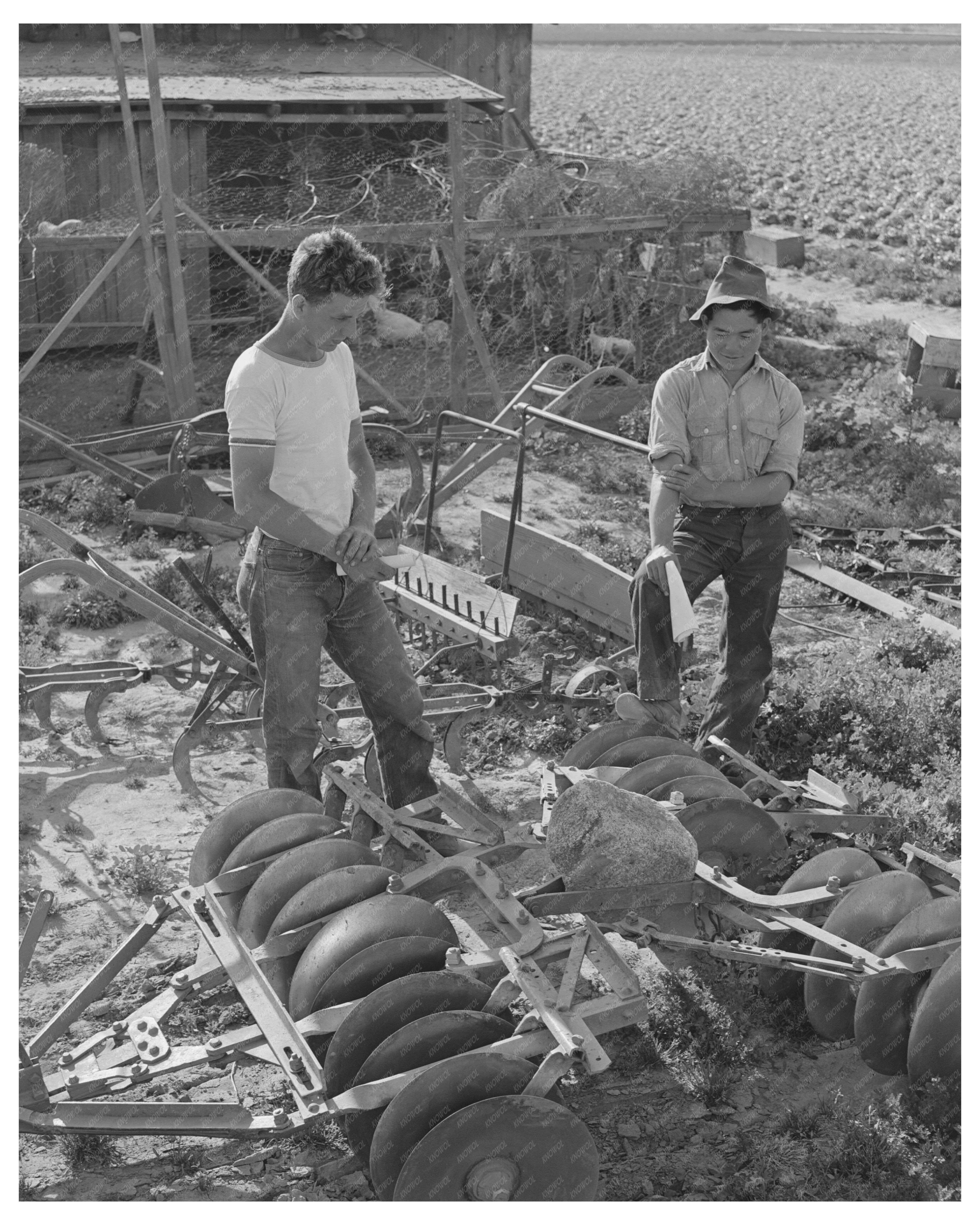 Farmer Examines Equipment Los Angeles County 1942