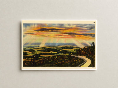 Sunset over road winding through nature. — Vintage Maryland Postcard