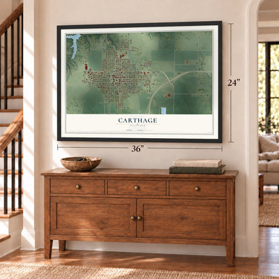 Carthage, Illinois map, 24 x 36 inch print in a black frame above a dresser by a staircase