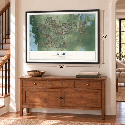Estero, Florida map, 24 x 36 inch print in a black frame above a dresser by a staircase