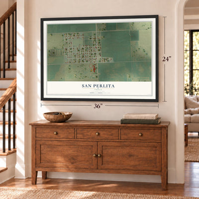 San Perlita, Texas map, 24 x 36 inch print in a black frame above a dresser by a staircase