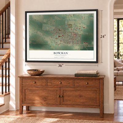 Bowman, North Dakota map, 24 x 36 inch print in a black frame above a dresser by a staircase