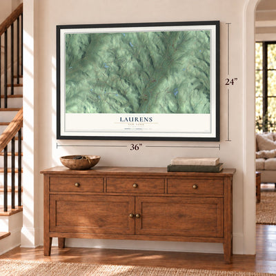 Laurens, New York map, 24 x 36 inch print in a black frame above a dresser by a staircase