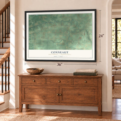 Conneaut, Erie County, Pennsylvania map, 24 x 36 inch print in a black frame above a dresser by a staircase